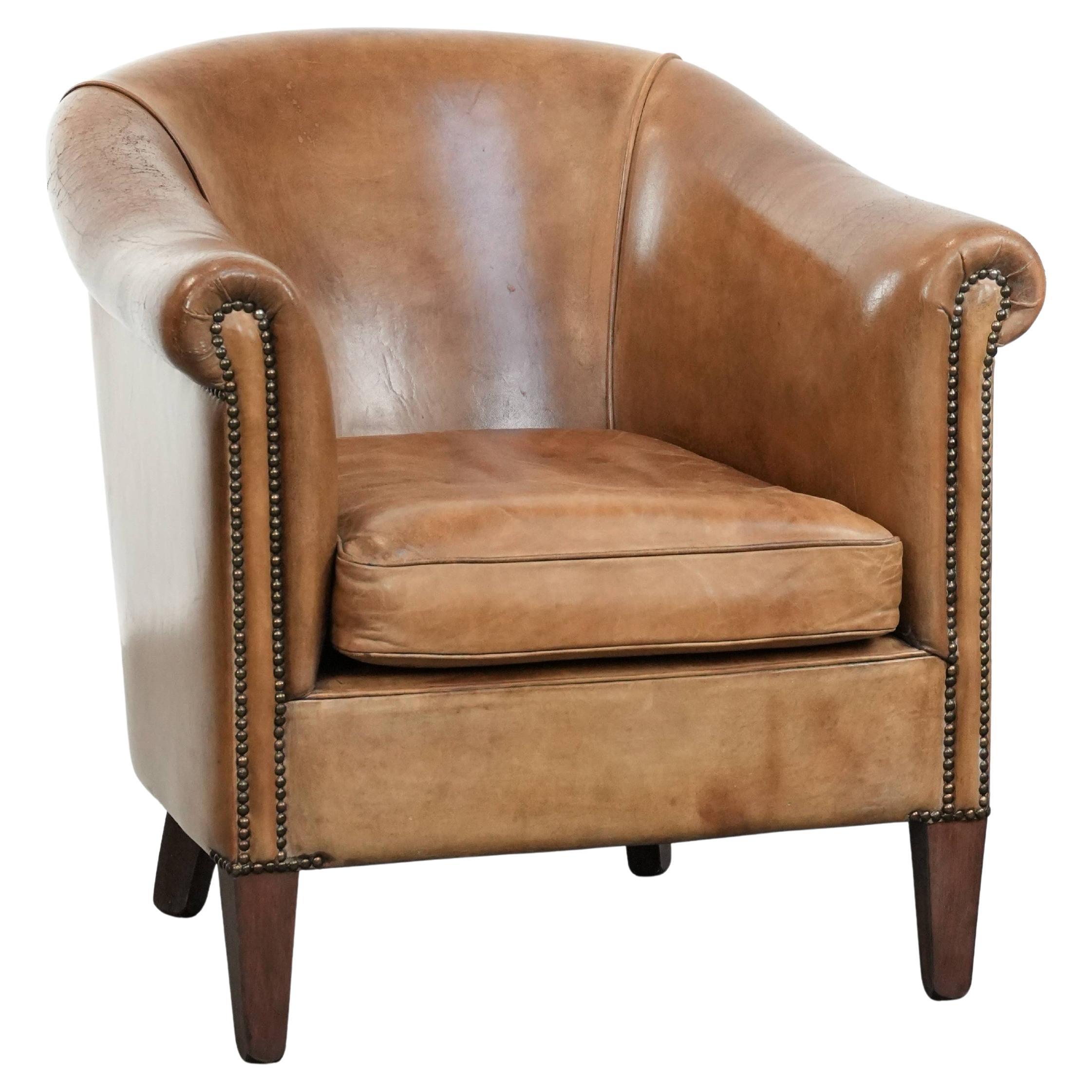 Characterful club chair made of sheepskin leather with light cognac colours
