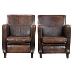 Ensemble de caractère de deux fauteuils en peau de mouton au design intemporel.