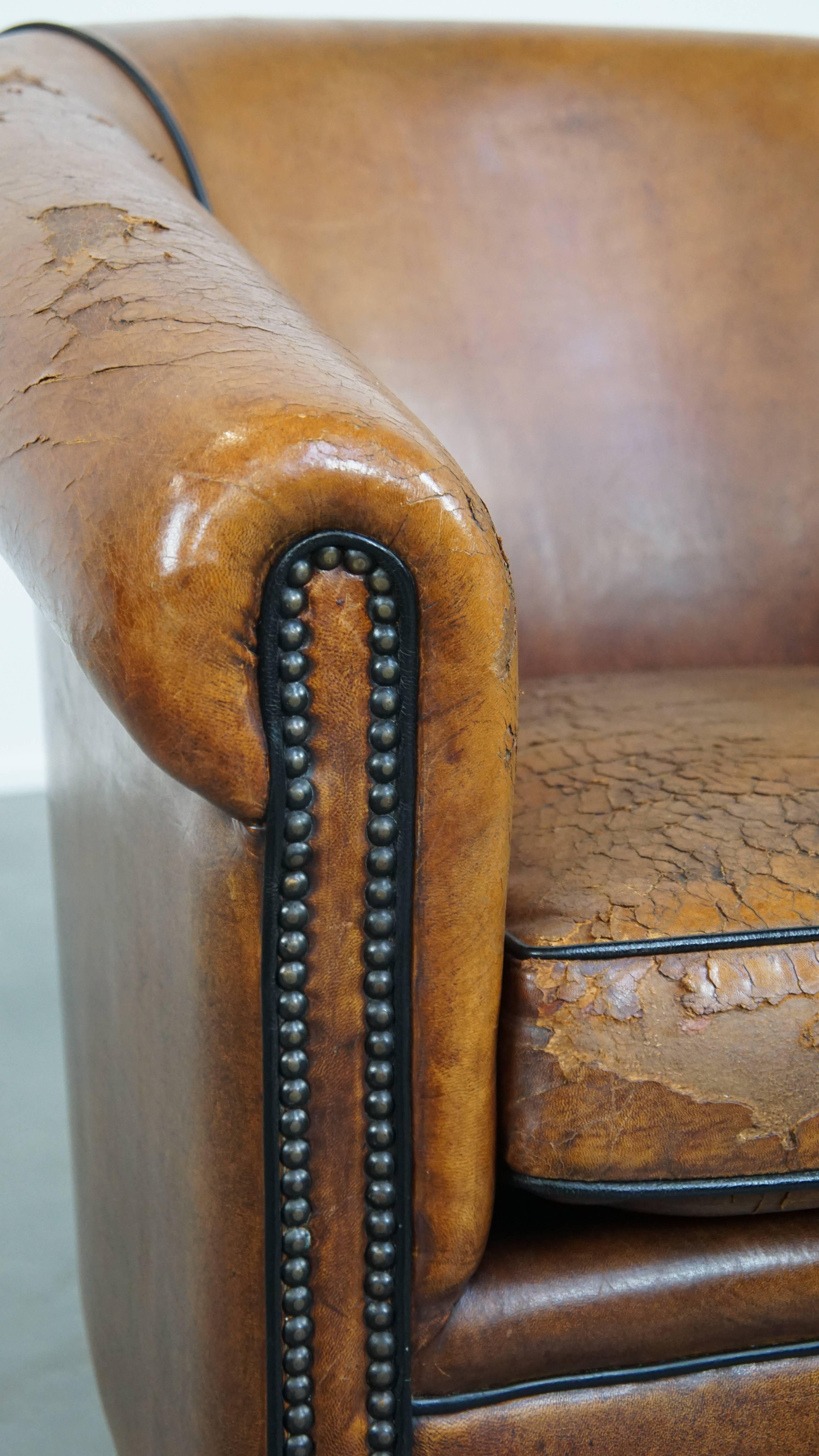 Characterful sheepskin club chair with a tough worn look and a beautiful patina For Sale 4