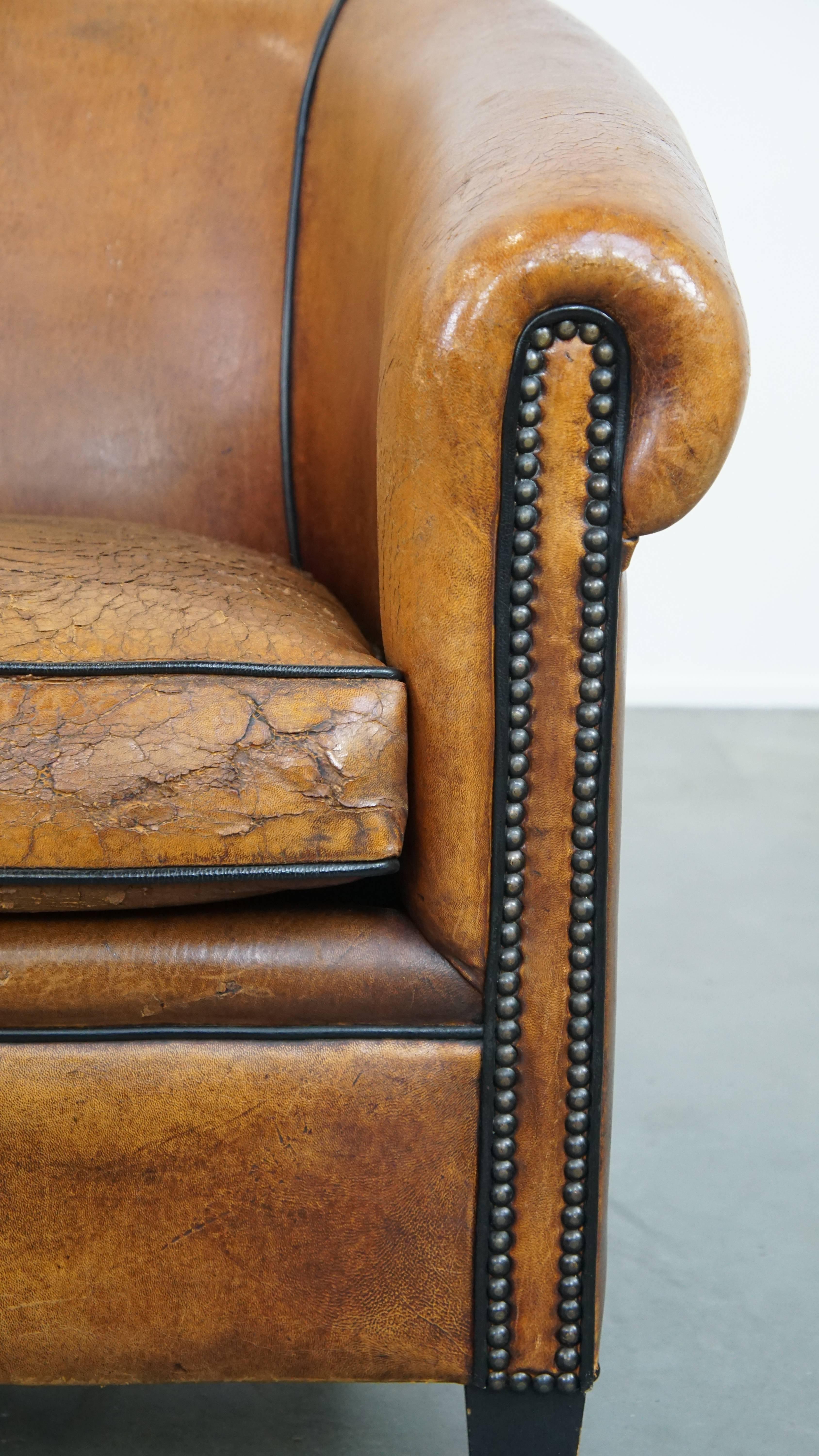 Characterful sheepskin club chair with a tough worn look and a beautiful patina For Sale 5