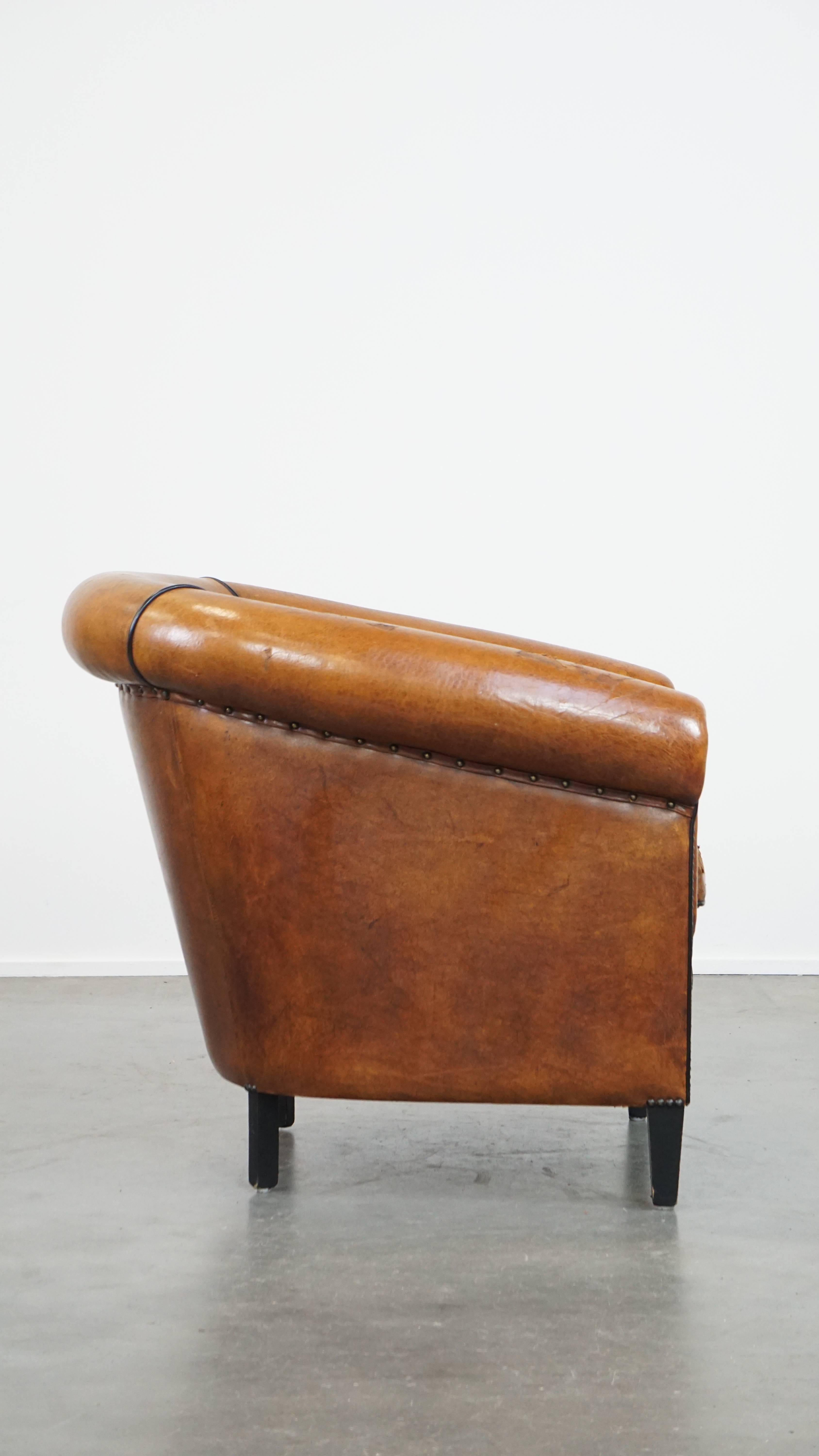 Hand-Crafted Characterful sheepskin club chair with a tough worn look and a beautiful patina For Sale