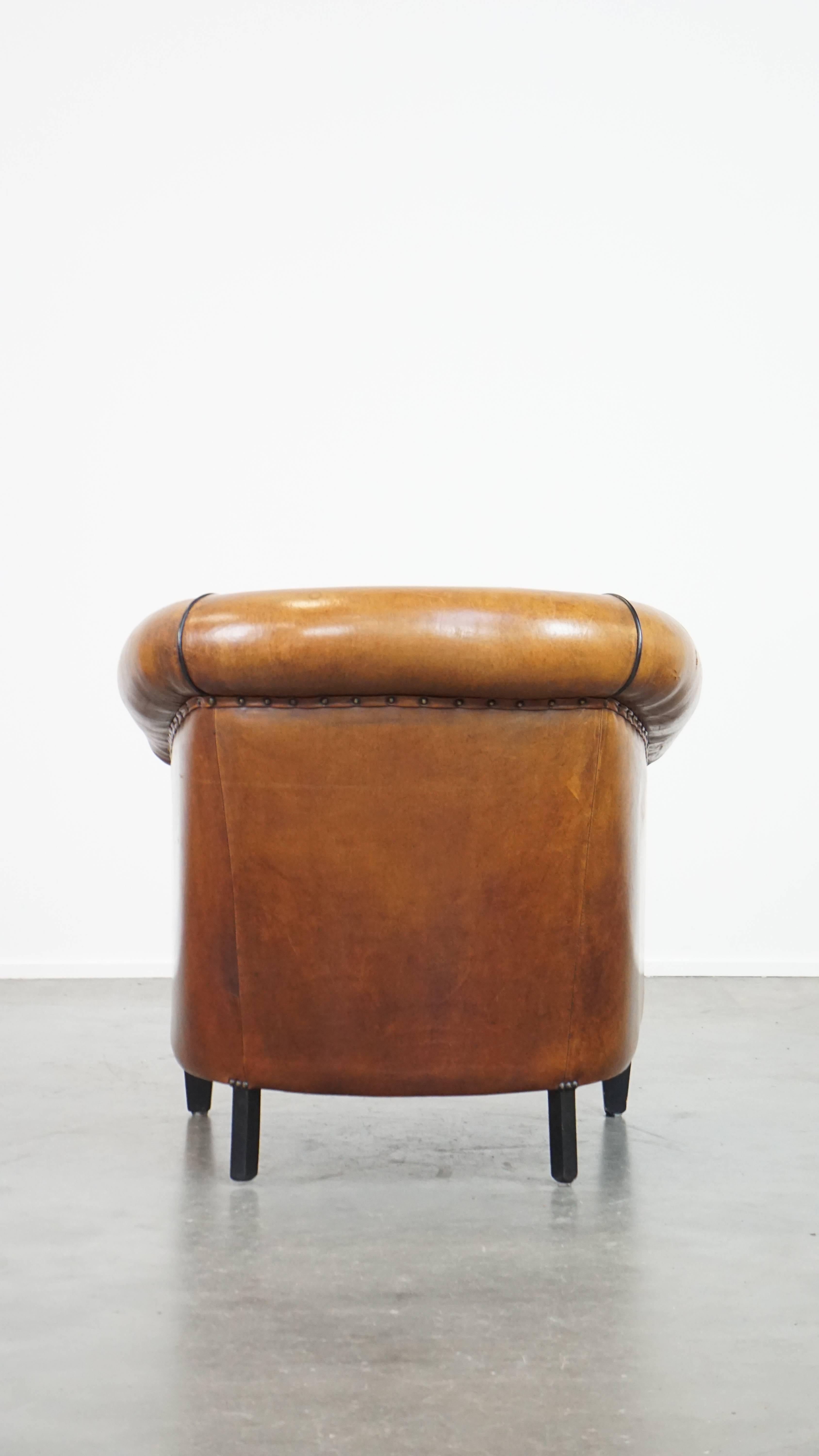Characterful sheepskin club chair with a tough worn look and a beautiful patina In Fair Condition For Sale In Harderwijk, NL