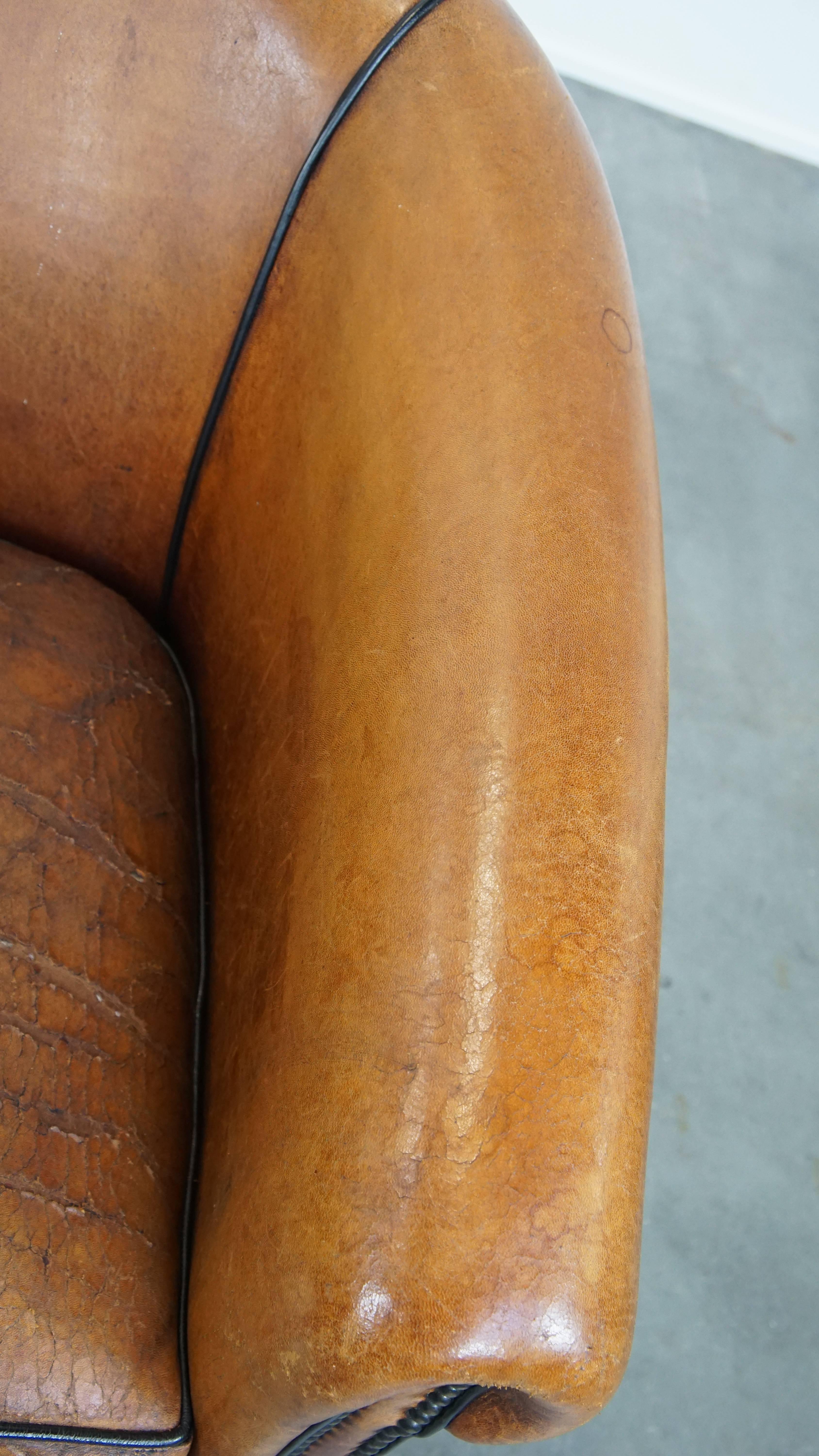 Characterful sheepskin club chair with a tough worn look and a beautiful patina For Sale 2