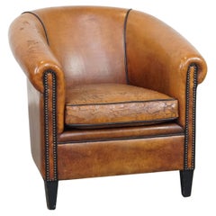 Characterful sheepskin club chair with a tough worn look and a beautiful patina