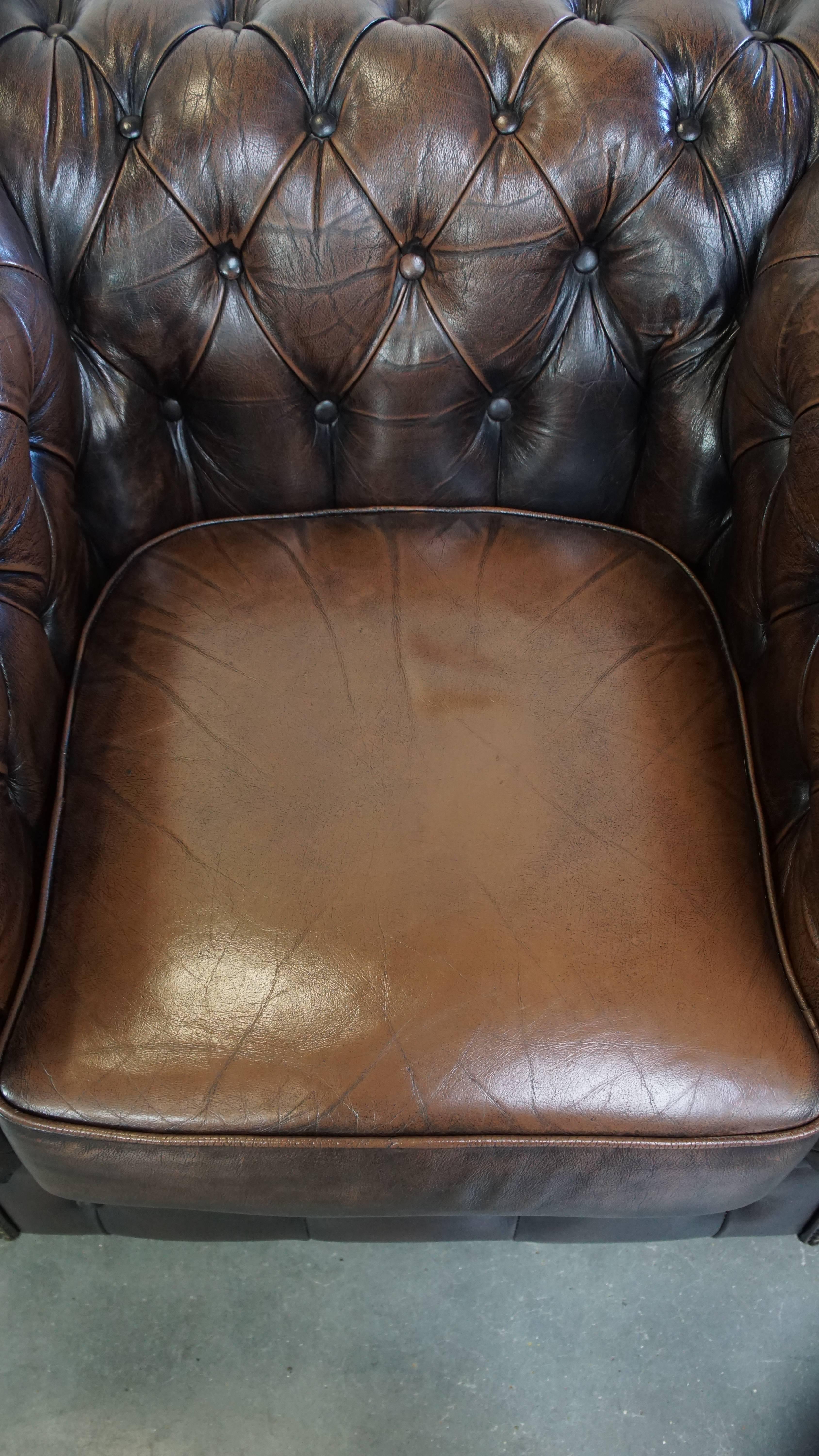 Cowhide Characterful, stately English Chesterfield armchair made of cowhide leather For Sale