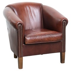 Characterful vintage sheepskin club chair with decorative nails
