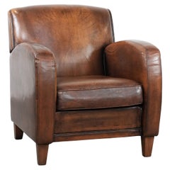 Fauteuil vintage de caractère en cuir de mouton avec de belles couleurs.