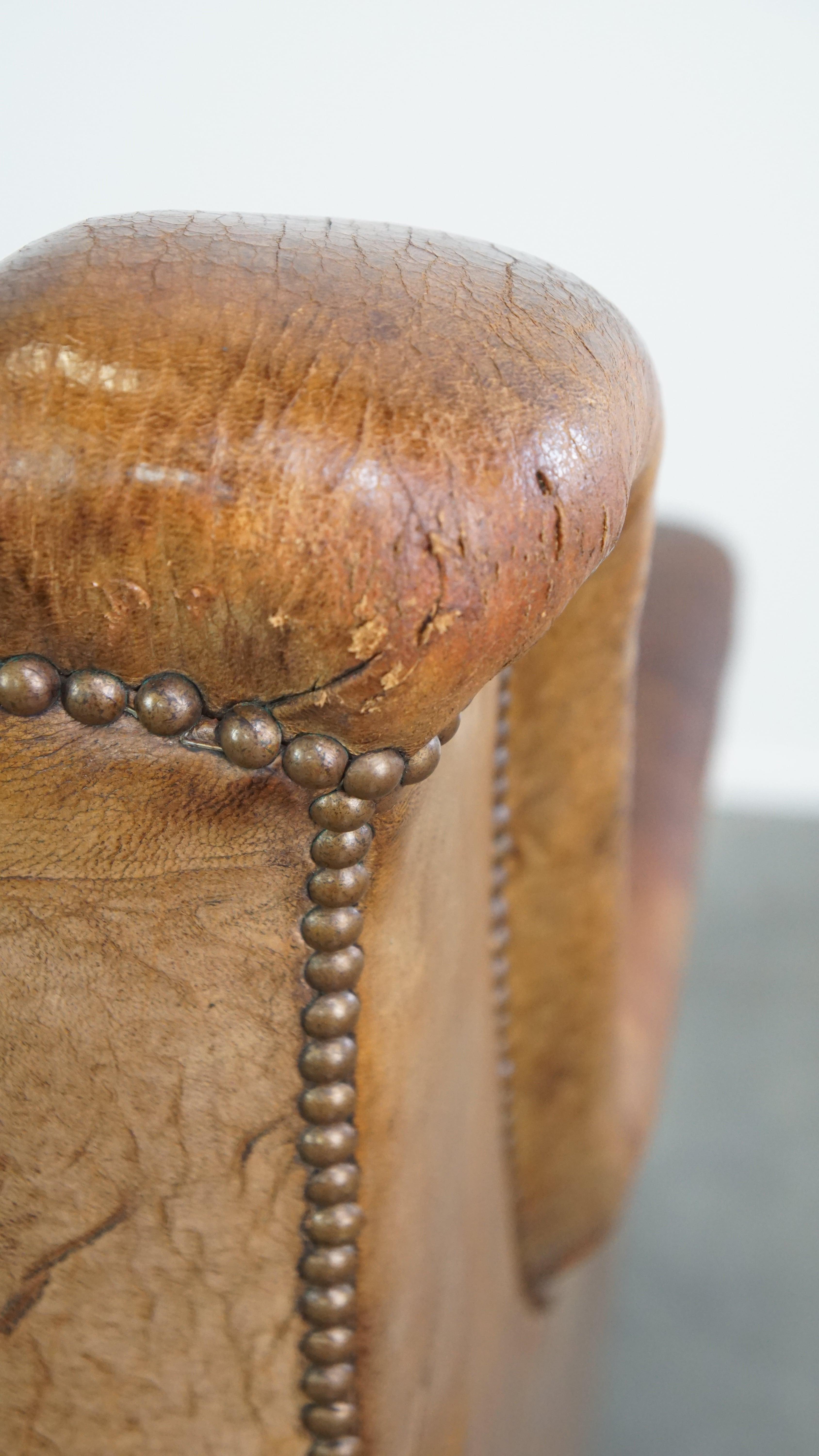 Characteristic antique sheepskin leather armchair with beautiful unique details For Sale 6