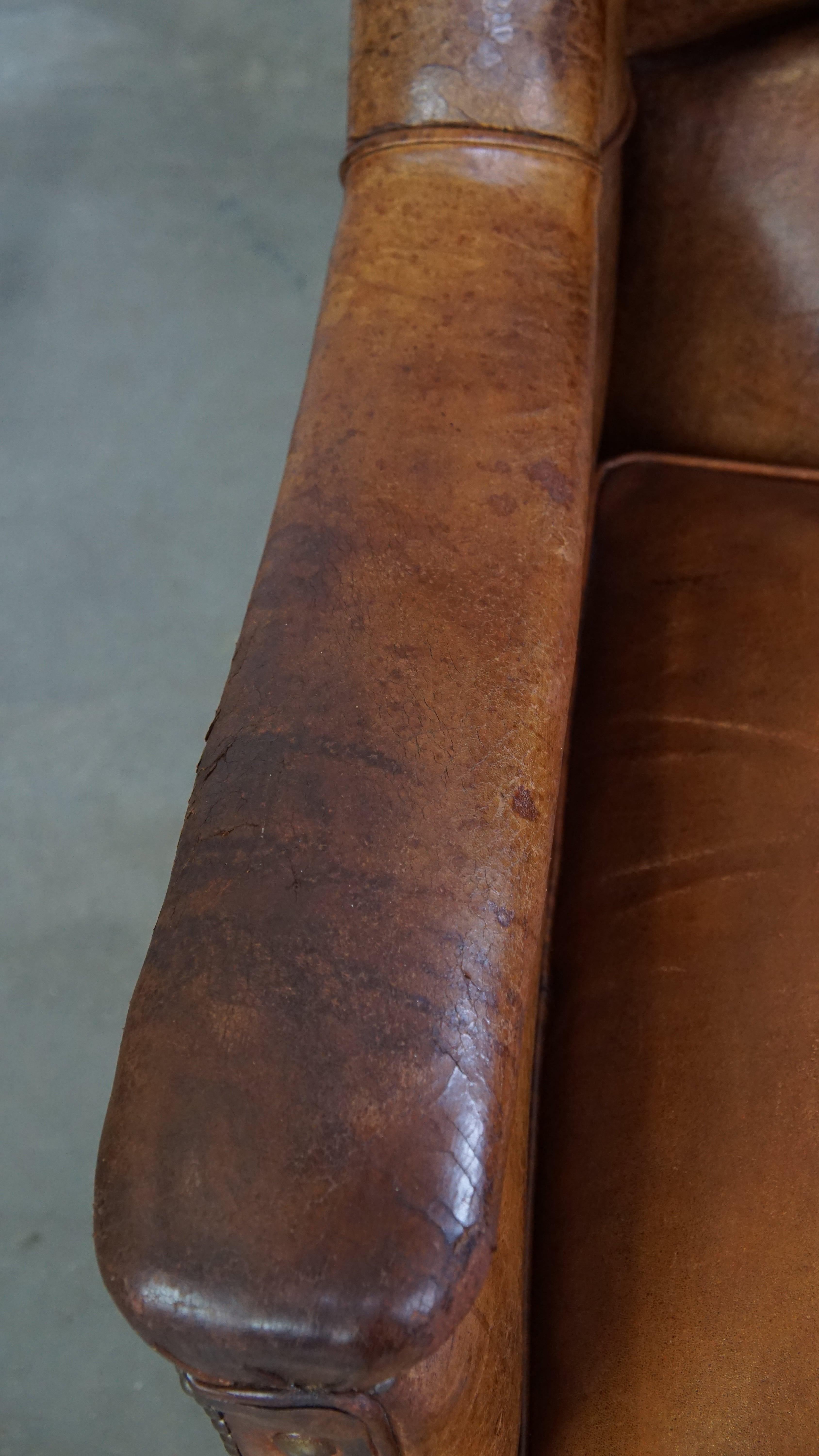 Characteristic antique sheepskin leather armchair with beautiful unique details For Sale 1