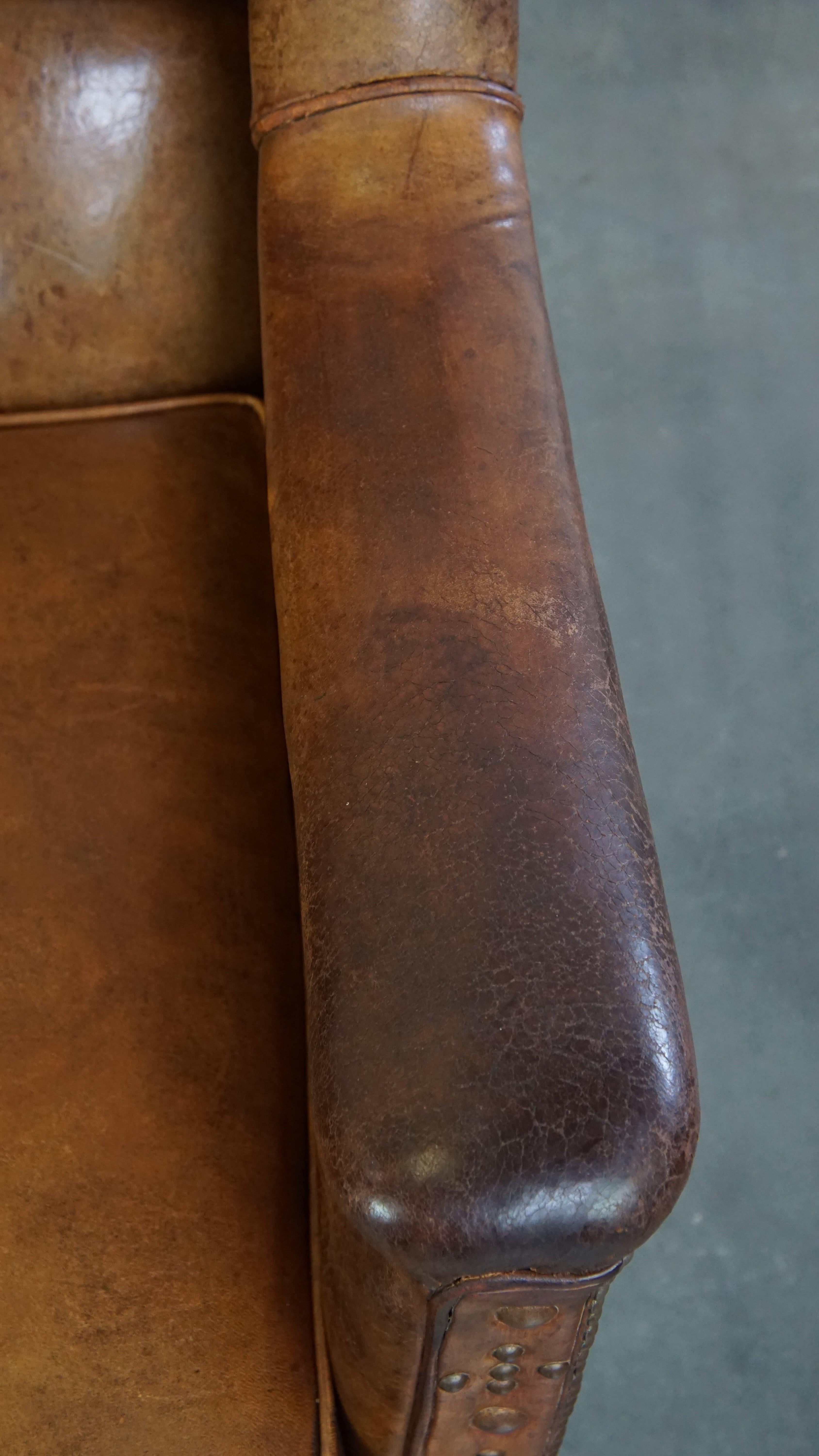 Characteristic antique sheepskin leather armchair with beautiful unique details For Sale 2