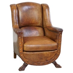 Characteristic antique sheepskin leather armchair with beautiful unique details