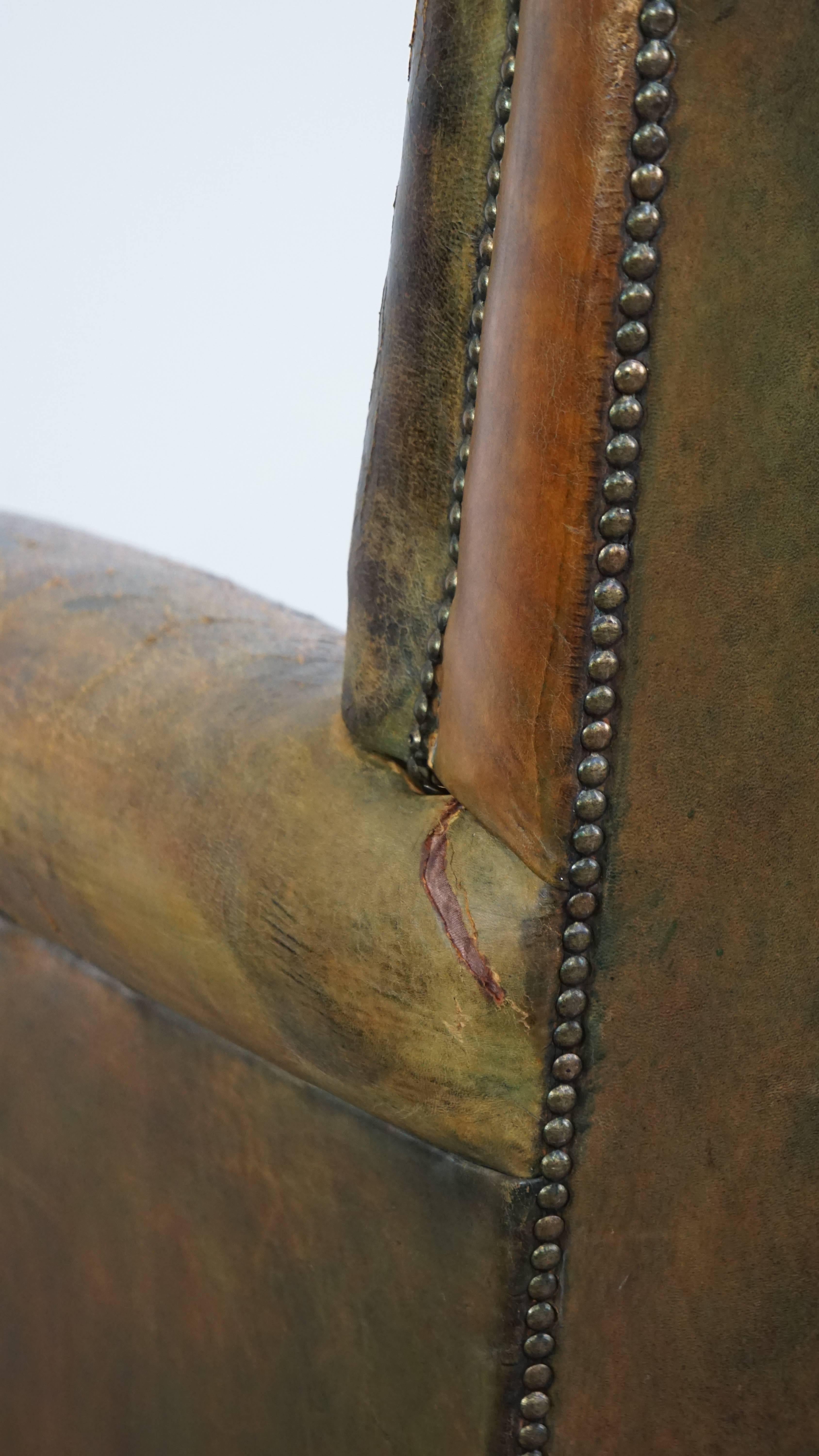 Characteristic unique green antique English leather armchair on wheels For Sale 4