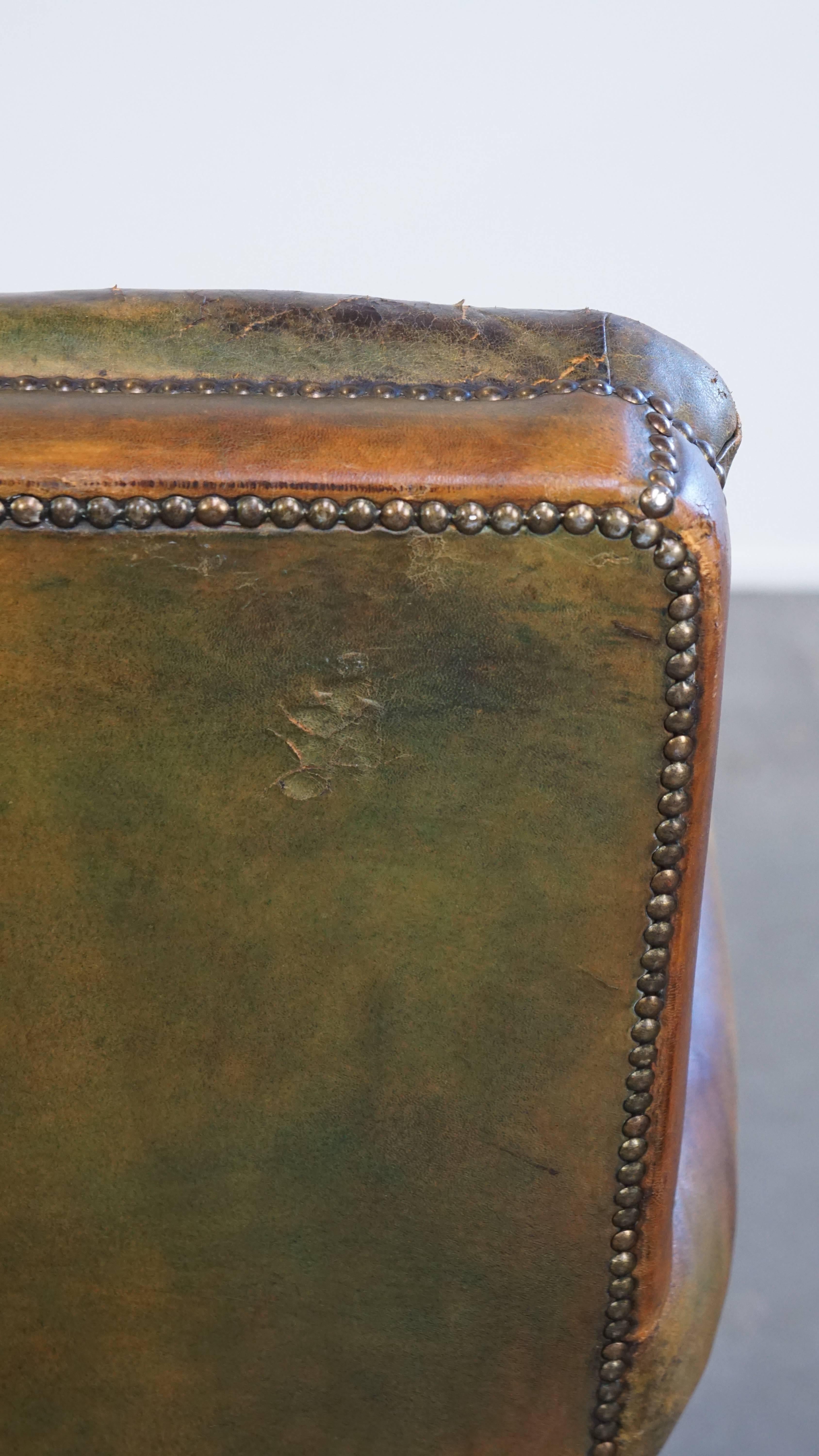 Characteristic unique green antique English leather armchair on wheels For Sale 5