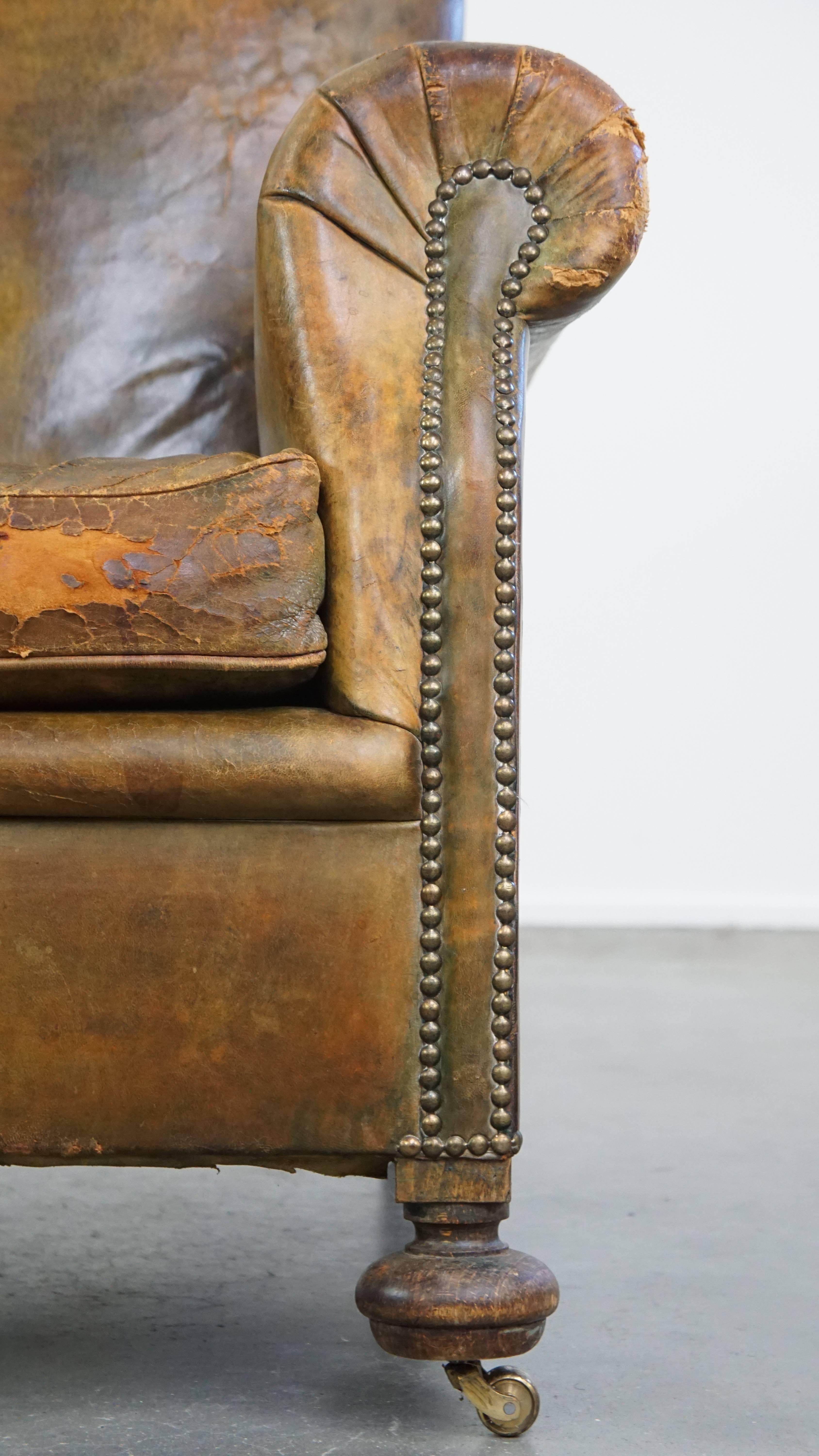 Characteristic unique green antique English leather armchair on wheels For Sale 11