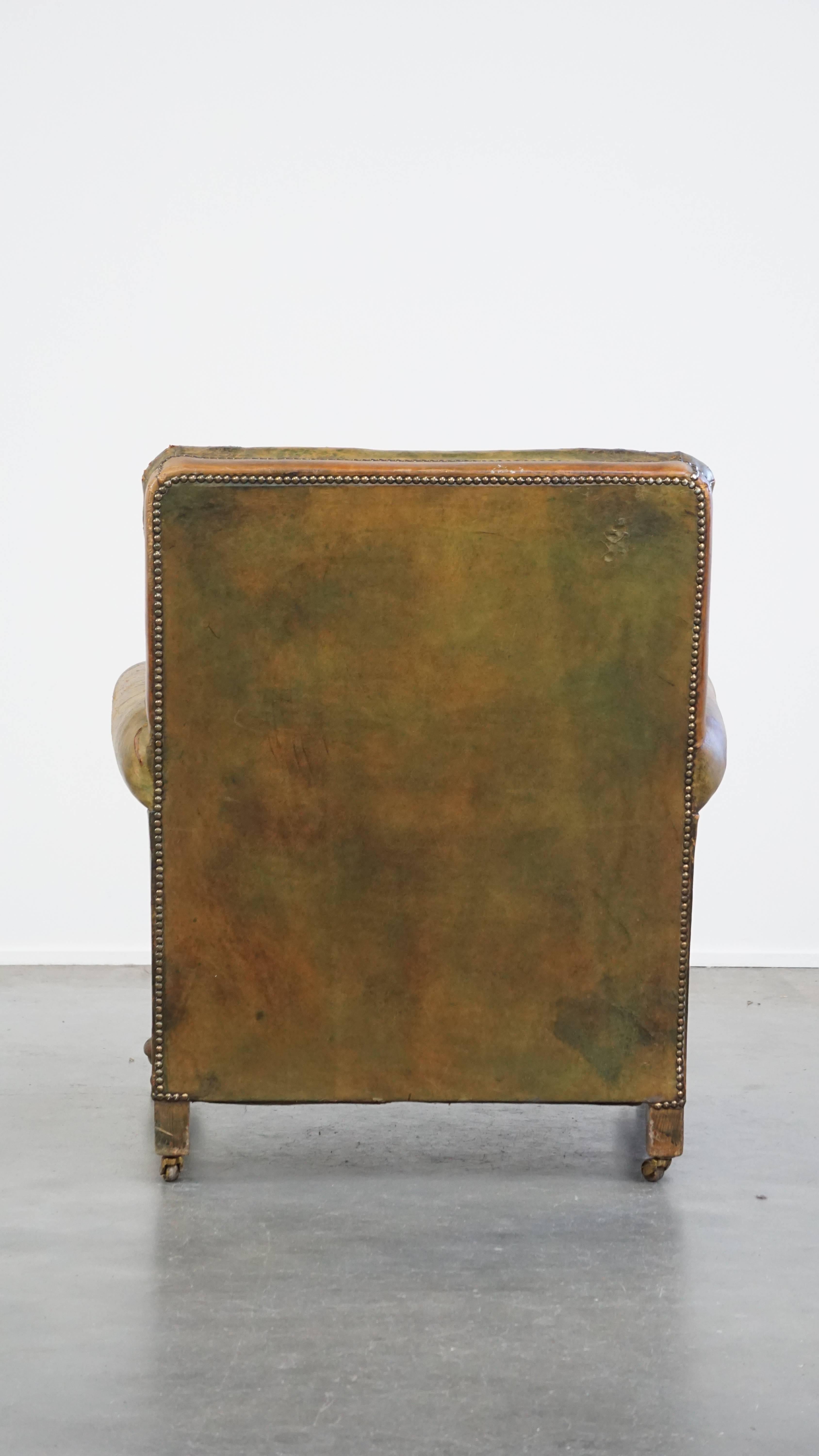 Characteristic unique green antique English leather armchair on wheels In Fair Condition For Sale In Harderwijk, NL