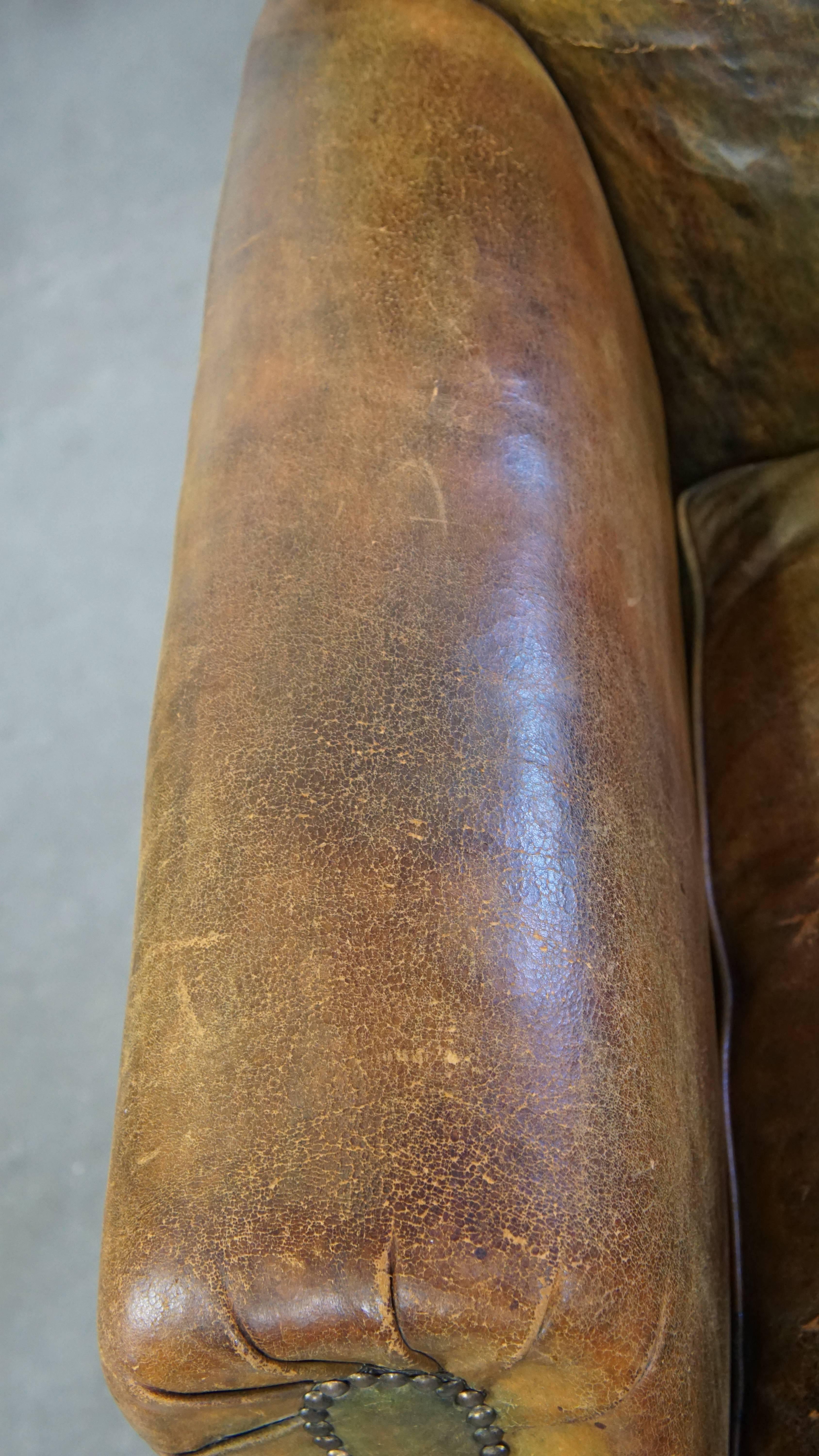 Characteristic unique green antique English leather armchair on wheels For Sale 1