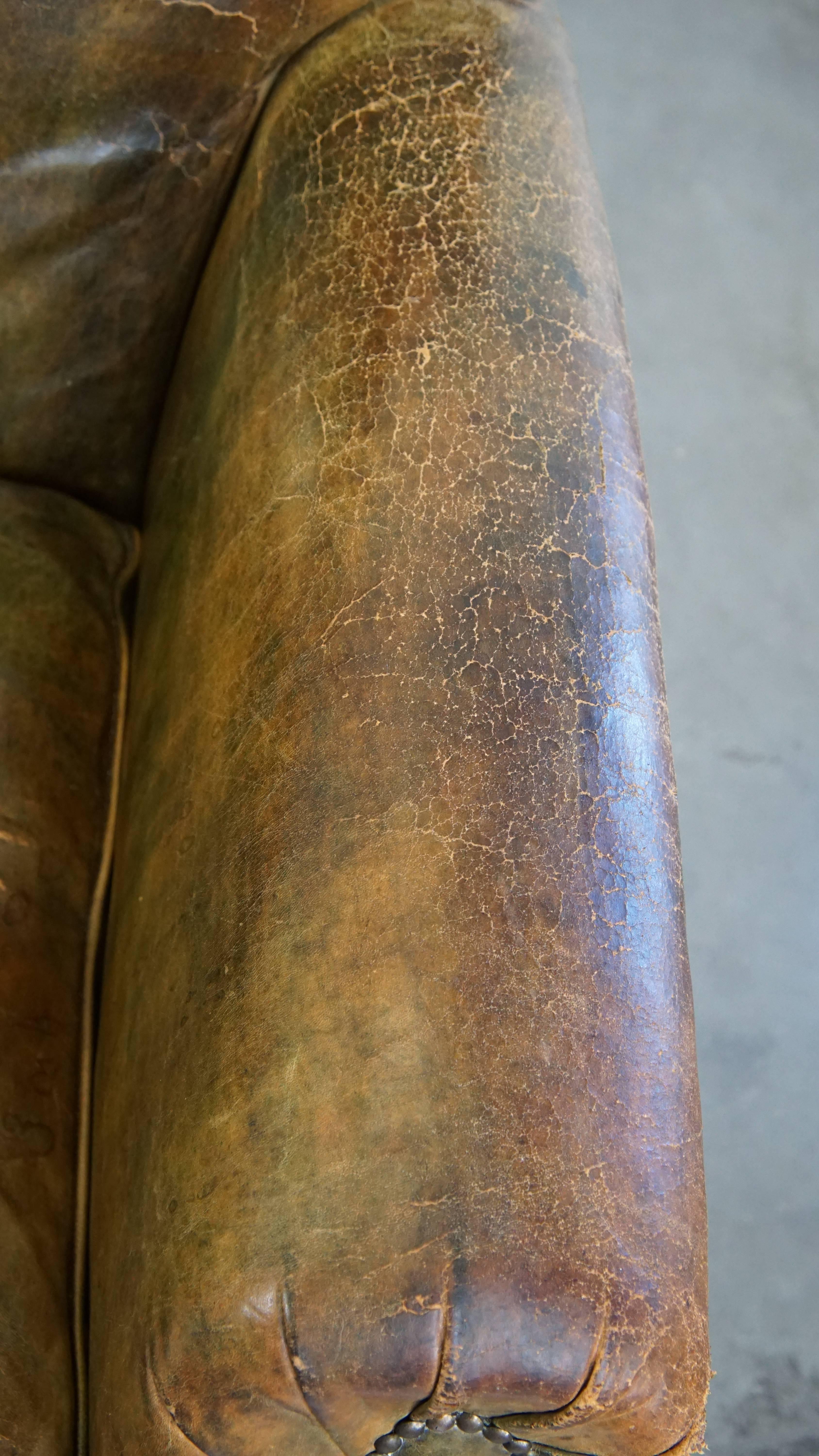 Characteristic unique green antique English leather armchair on wheels For Sale 2