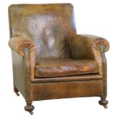 Characteristic unique green antique English leather armchair on wheels