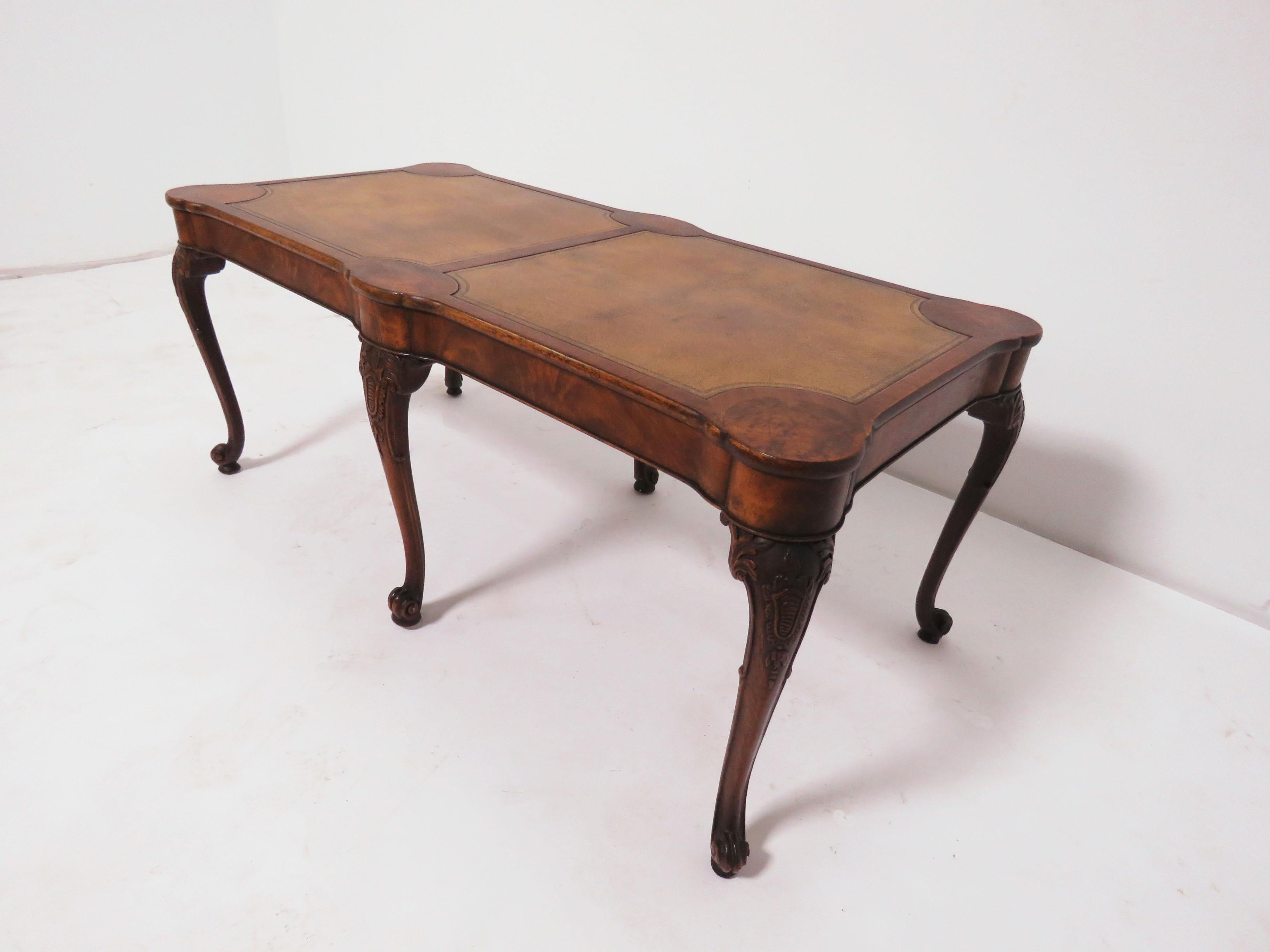 A Georgian style hand carved burr walnut coffee table with embossed leather top, by Charak of Boston, dated 1937.