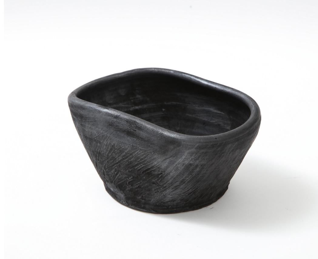 Brutalist terracotta bowl. Uniquely cooked directly on charcoal. Made exclusively for Facto Atelier Paris. Silver reflections. Not suitable for food contact.