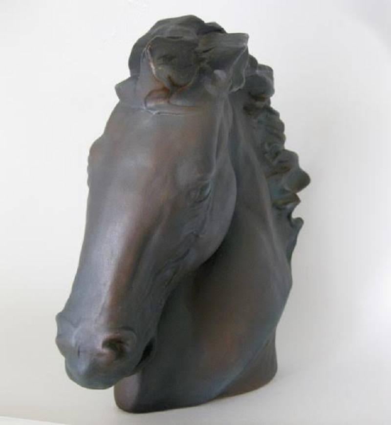 Large ceramic horse head bust, finished in a charcoal with highlights of bronze, with a matte-finished glaze. The horse has an open mouth with a flowing mane. Has original felt bottom that is numbered 91002. Would look great in any Hollywood Regency