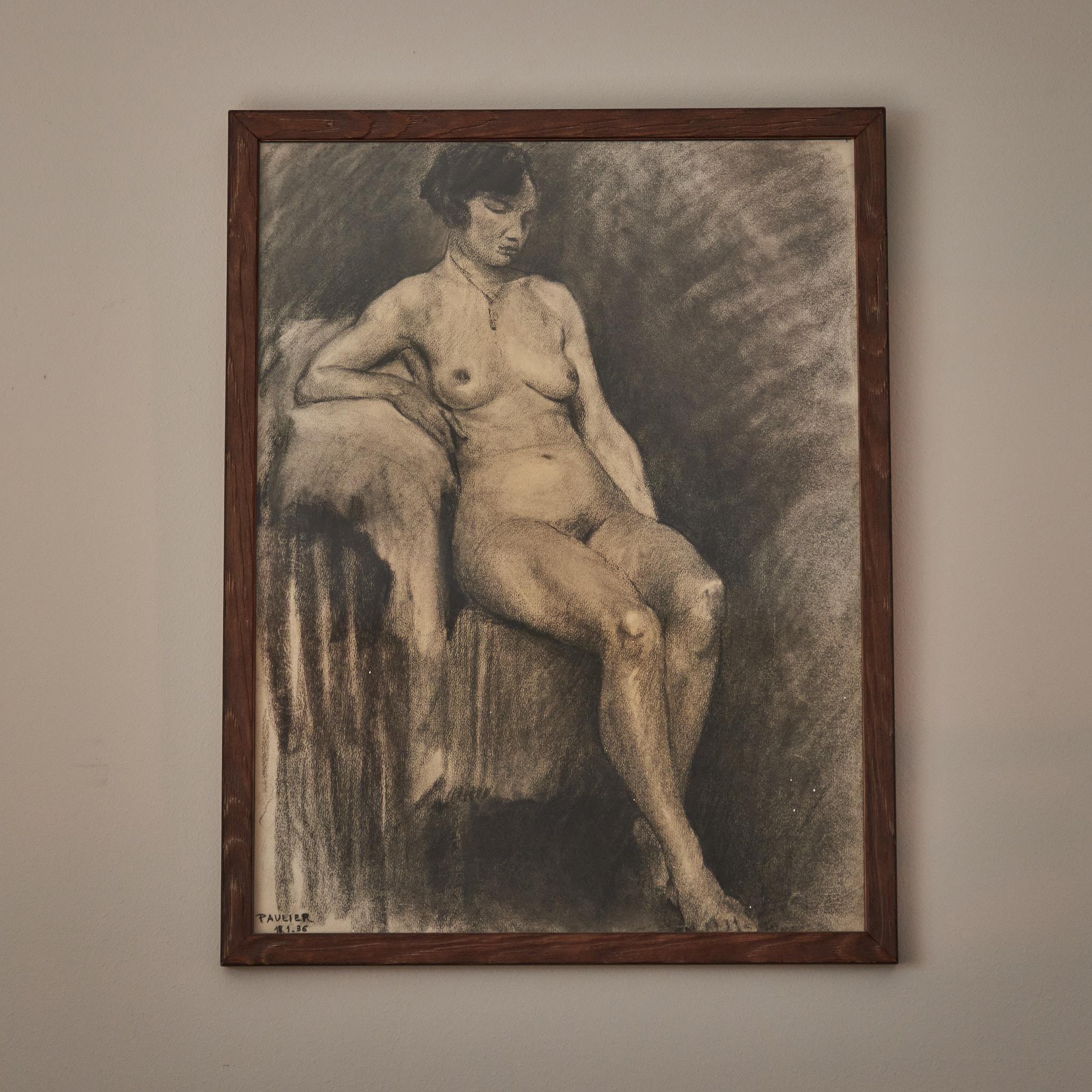 Early 20th-century French Academy-style charcoal drawing of seated nude female model. Mounted in a custom wood frame, the image has an introspective quality, and a beautiful sense of line. 
