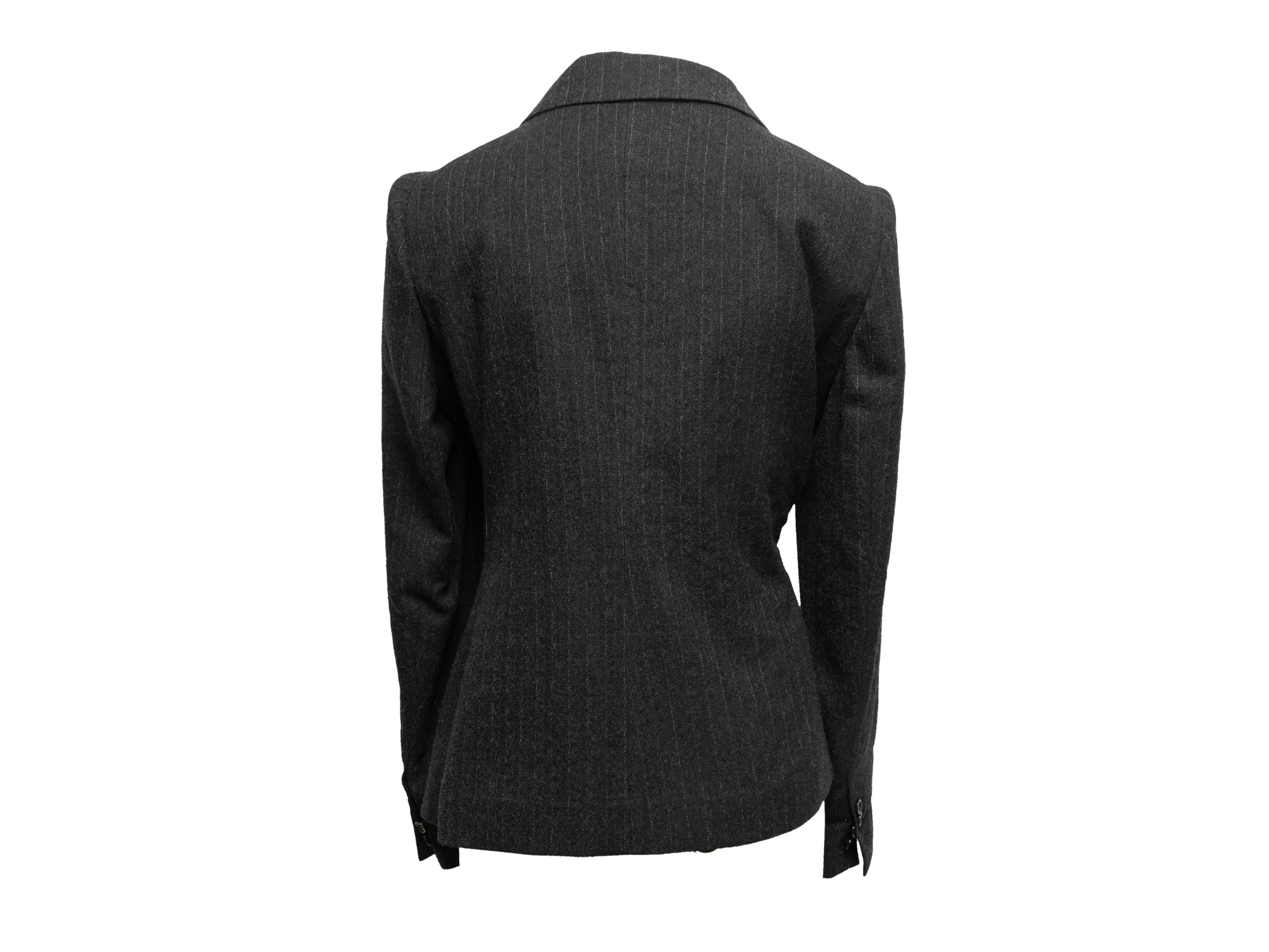Charcoal virgin wool pinstriped blazer by Maison Margiela. Circa 2017. Peaked lapels. Asymmetrical front closure. 28