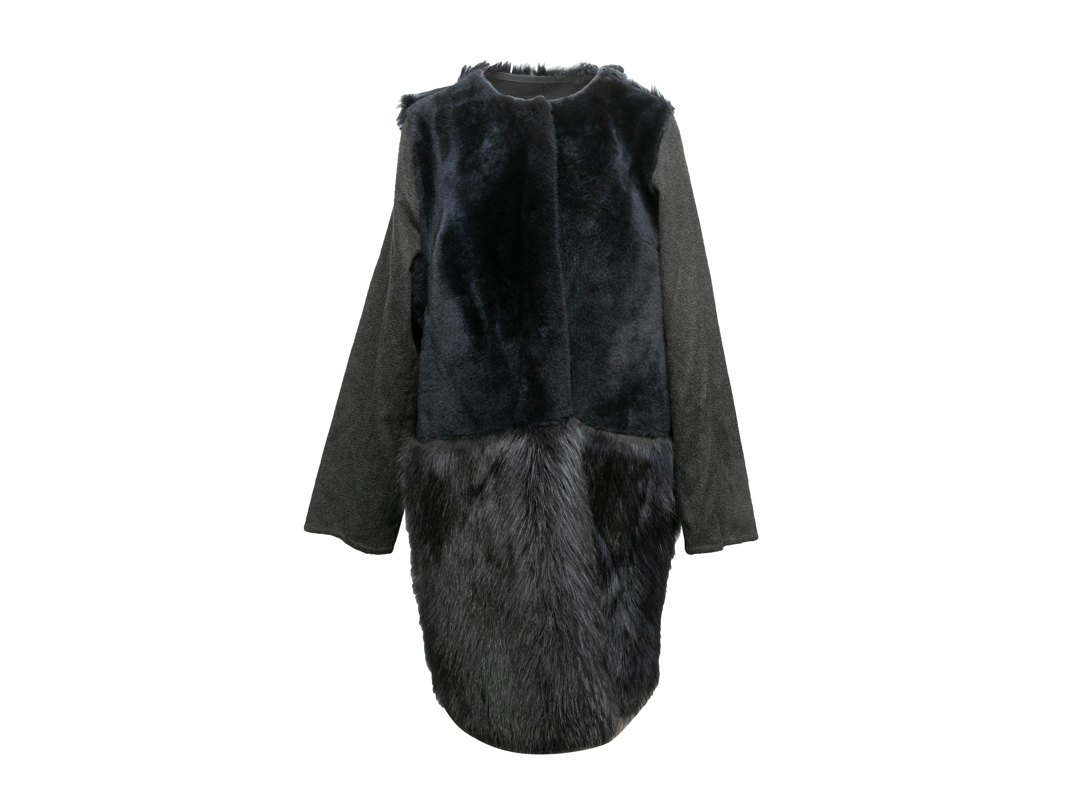 Charcoal and navy fur and shearling collarless coat by Yves Salomon. Crew neck. Textile sleeves. Concealed front closure. 46