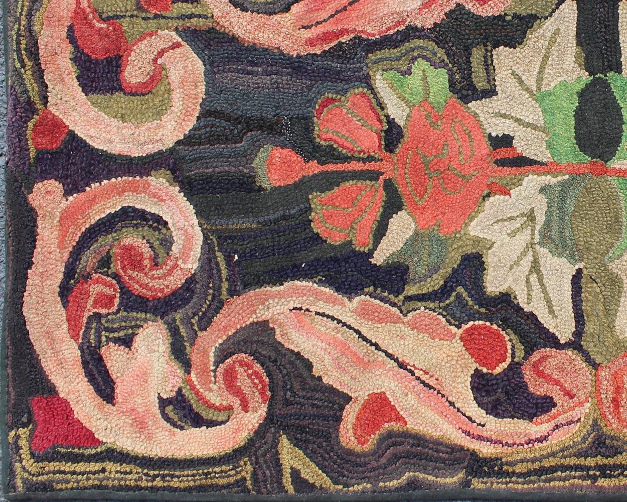 Charcoal, red, and green antique American Hooked rug with large flower design, rug ml-500, country of origin / type: United States / Hooked, circa 1900

This colorful vintage American Hooked rug depicts a variety of vines and blossoming flowers in