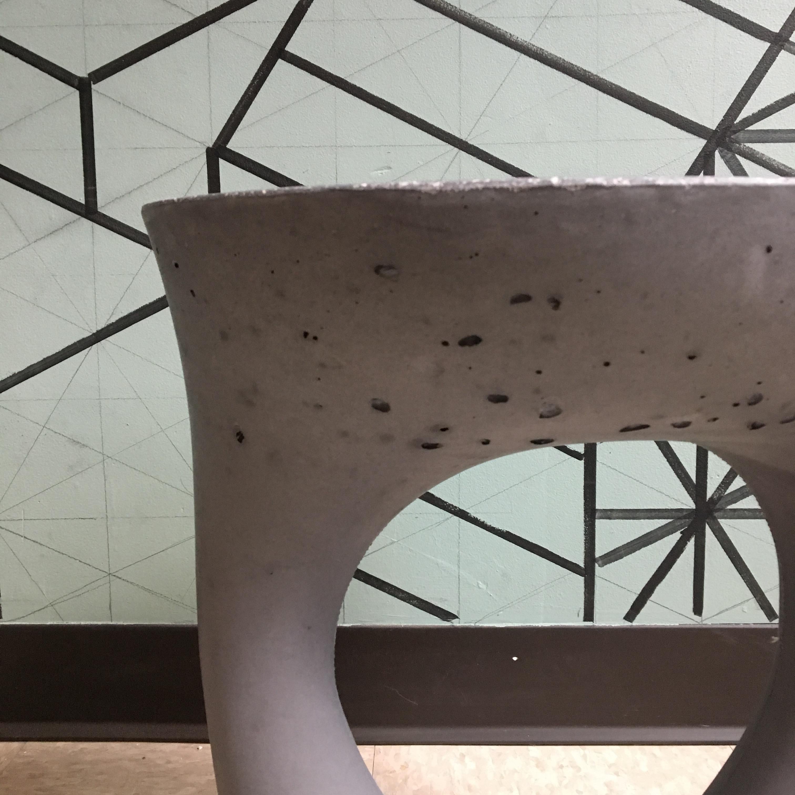 This piece is a factory 2nd. It has a few more air bubbles than normal and some very minor discoloration.

Industrial, organic and sculptural, the Kreten side tables are concrete furniture like you haven’t seen before. Original pieces are created
