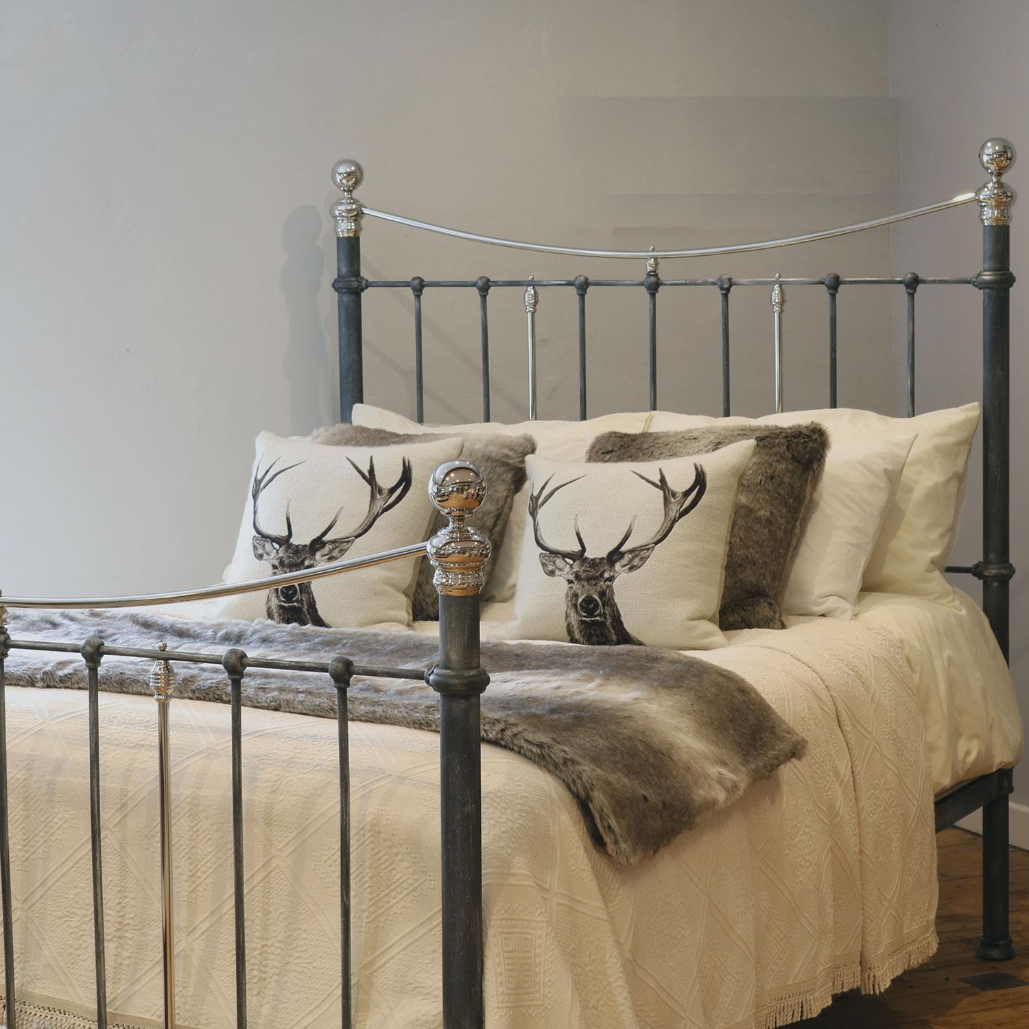 A simple cast iron Victorian bedstead finished in charcoal with nickel plated rails, knobs and collars, and simple round mouldings in a classic style. 

This bed accepts a UK king size or US queen size (5ft, 60in or 150cm wide) base and mattress
