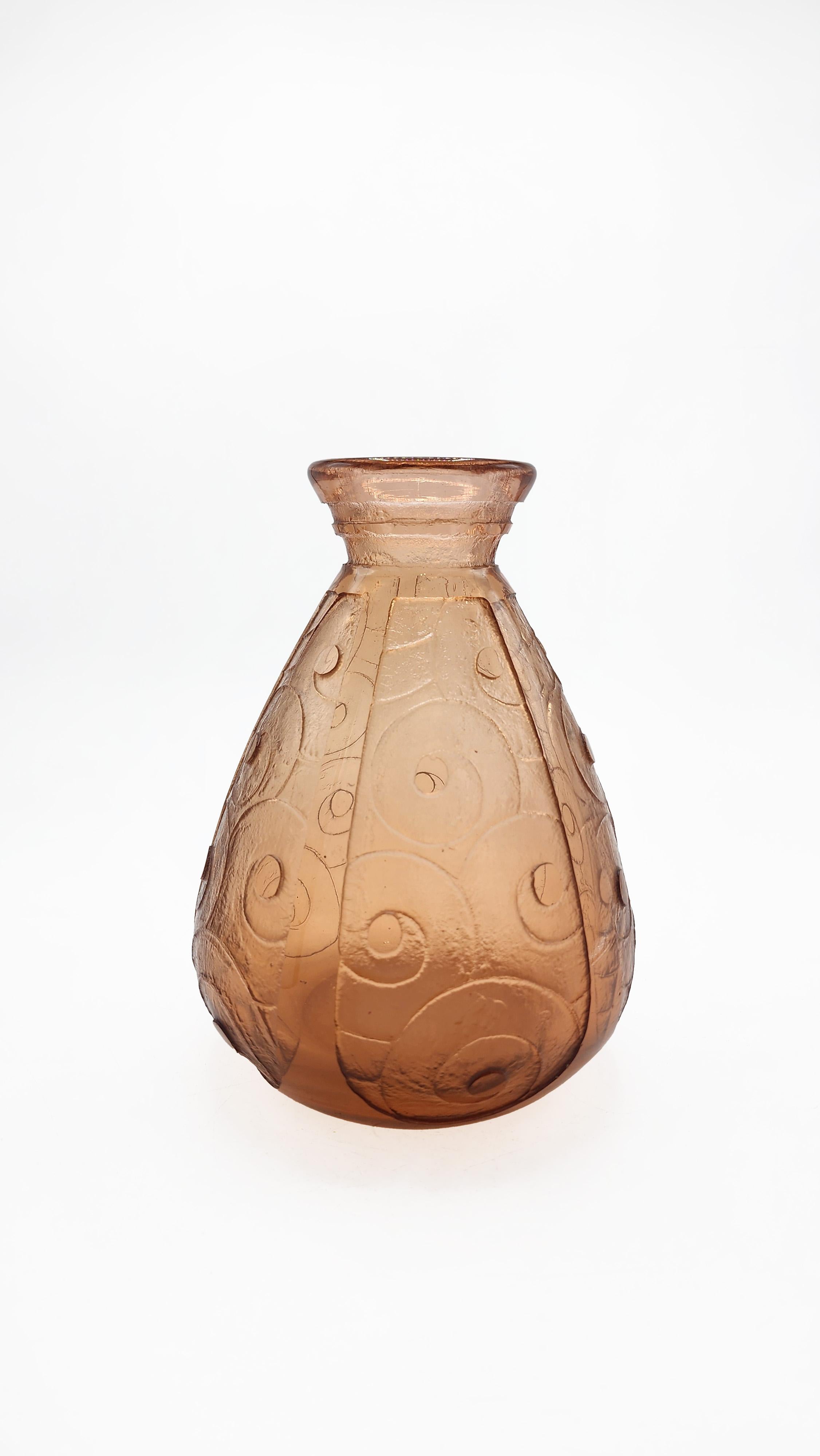 Charder Le Verre Français Carved Glass Vase
Charder Le Verre Français carved glass vase. It features a bulbous body that tapers to a short neck with a slightly flared mouth. The glass is amber or light brown in color and is decorated with a carved