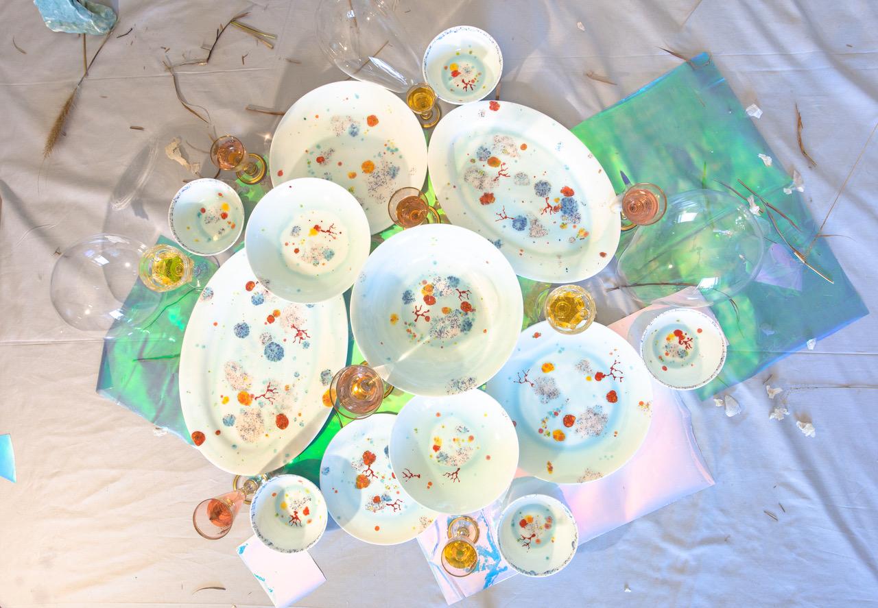 Handcrafted in Italy from the finest porcelain, this blue seabed rim charger has corals lying on a bright bottom surrounded by mysterious multicolored gems floating amid brushes of light pink sand sprinkled with black dots.

Blue seabed rim