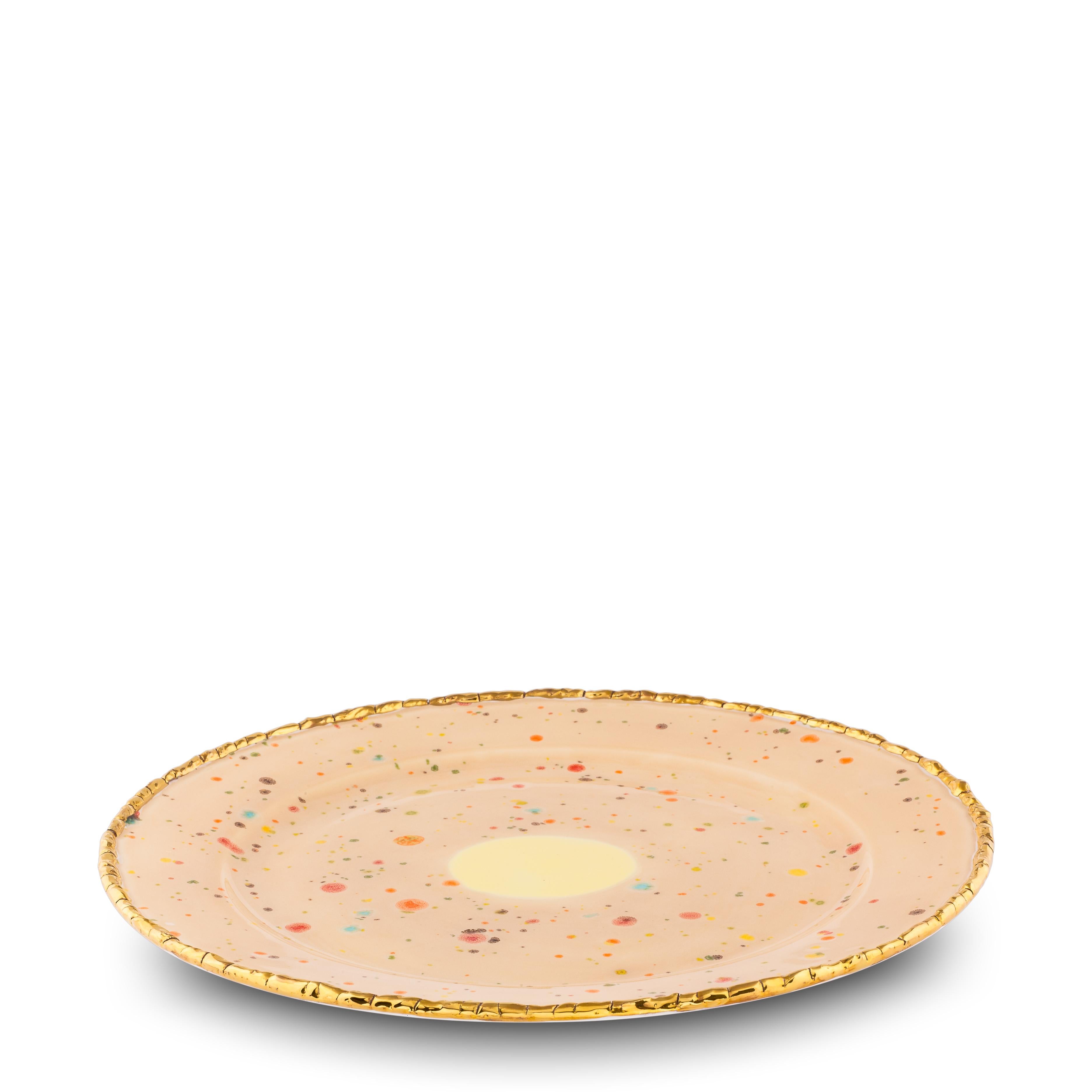 Handcrafted in Italy from the finest porcelain, this Chestnut charger plate has an original golden crackled edge emphasizes the warm sandy surface covered with little multicolor dots and the bright yellow splotch at the center.

Charger plate with