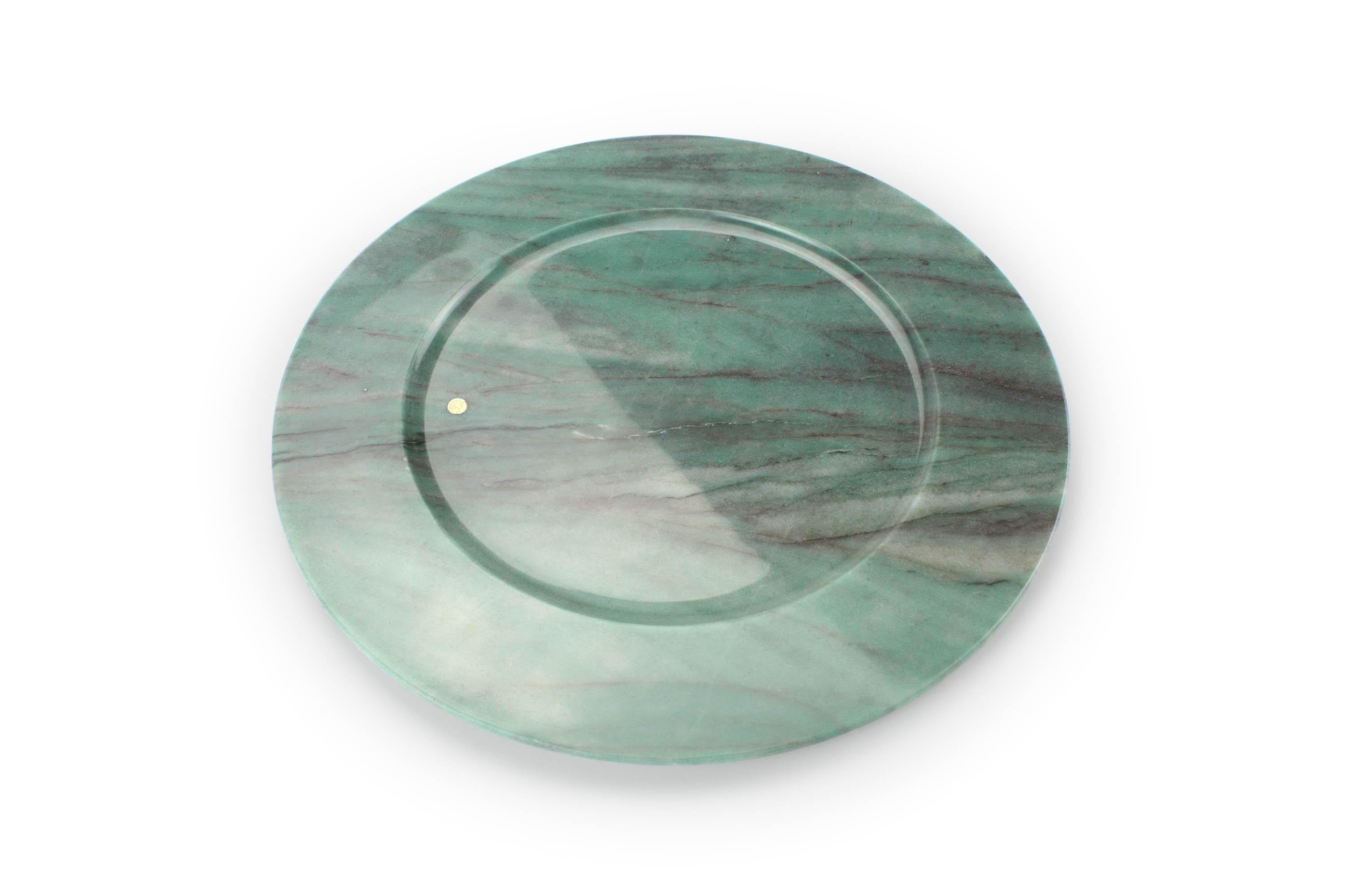 Hand carved charger plate from semi-precious green quartzite.
Multiple use as charger plates, plates, platters and placers. 

Dimensions: D 33 x H 1.9 cm. Available in different marbles, onyx and quartzite. 

100% Hand made in Italy. 

Marble is a