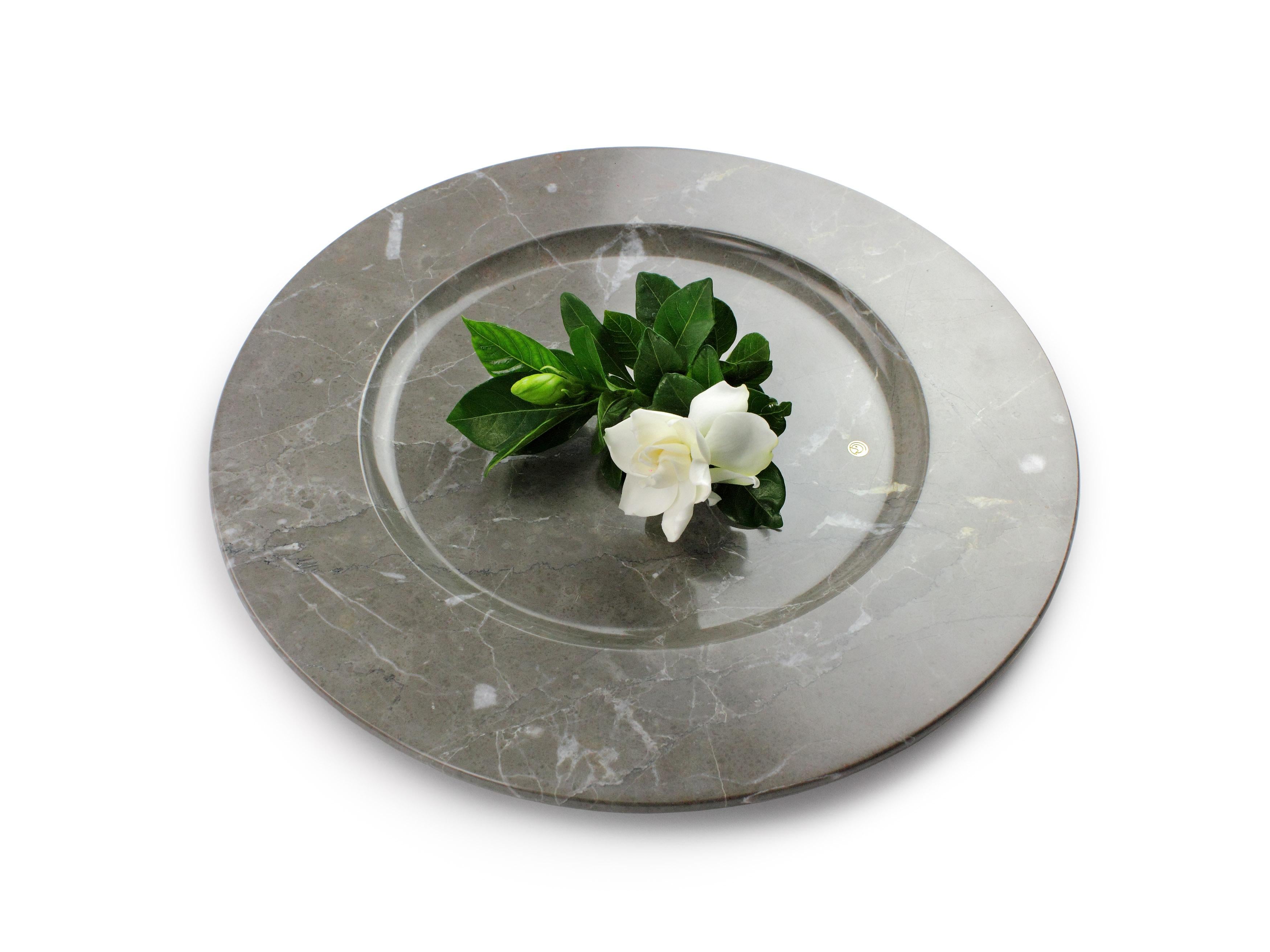 Hand carved charger plate from imperial grey marble. Multiple use as charger plates, plates, platters and placers. 

Dimensions: D 33 x H 1.9 cm. Available in different marbles, onyx and quartzite. 

100% Hand made in Italy.

Marble is a natural