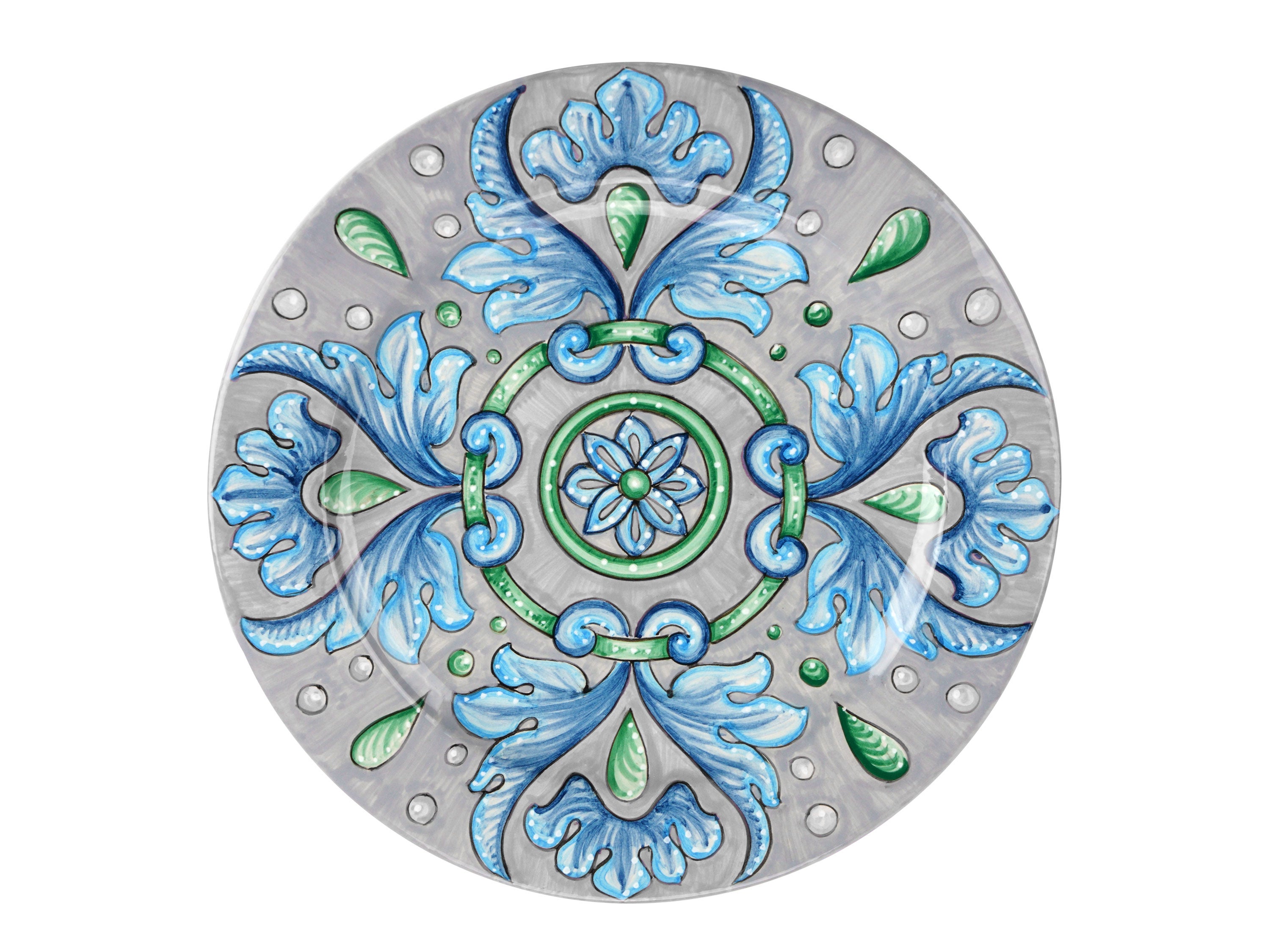 Set of six majolica charger plates is handmade and hand-painted in Italy following the original Renaissance painting technique, unchanged over time, which we observe to the letter.
The elegant decoration is composed of a halo of blue foliage that