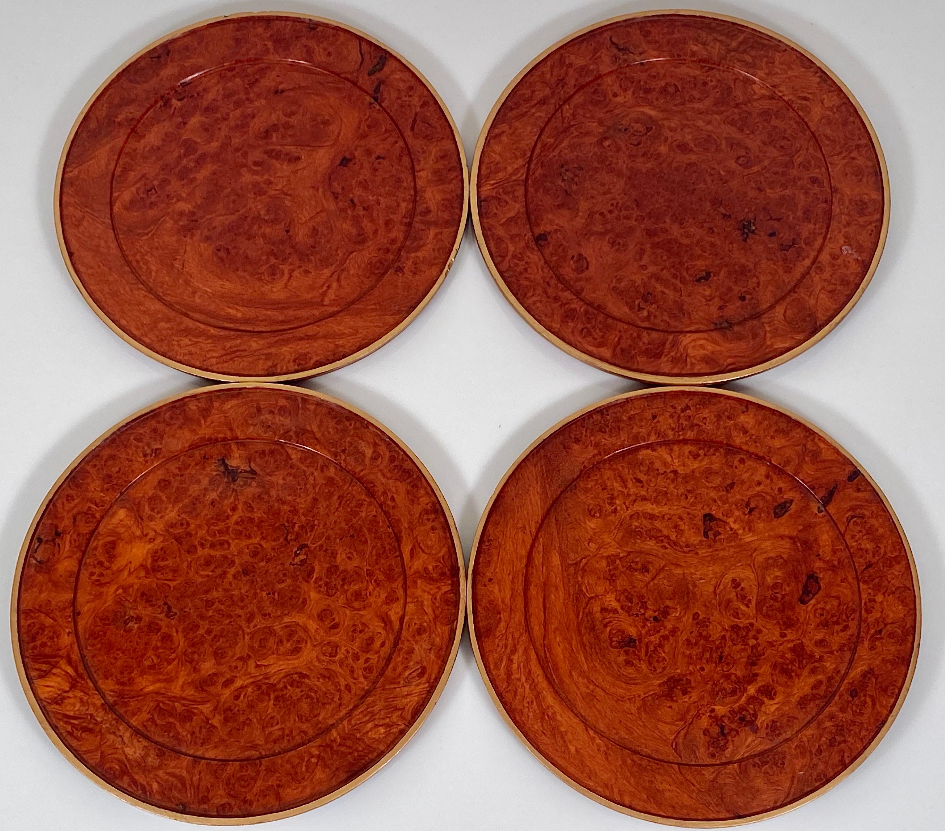 Modernist vintage set of eight wooden walnut burr plates, circa 1960
Minimal in shape, each plate is turned carved out of walnut burr with a shallow lip and a circular cavity on the inside with faded gilt gold on outside edge. 
Two of eight plates