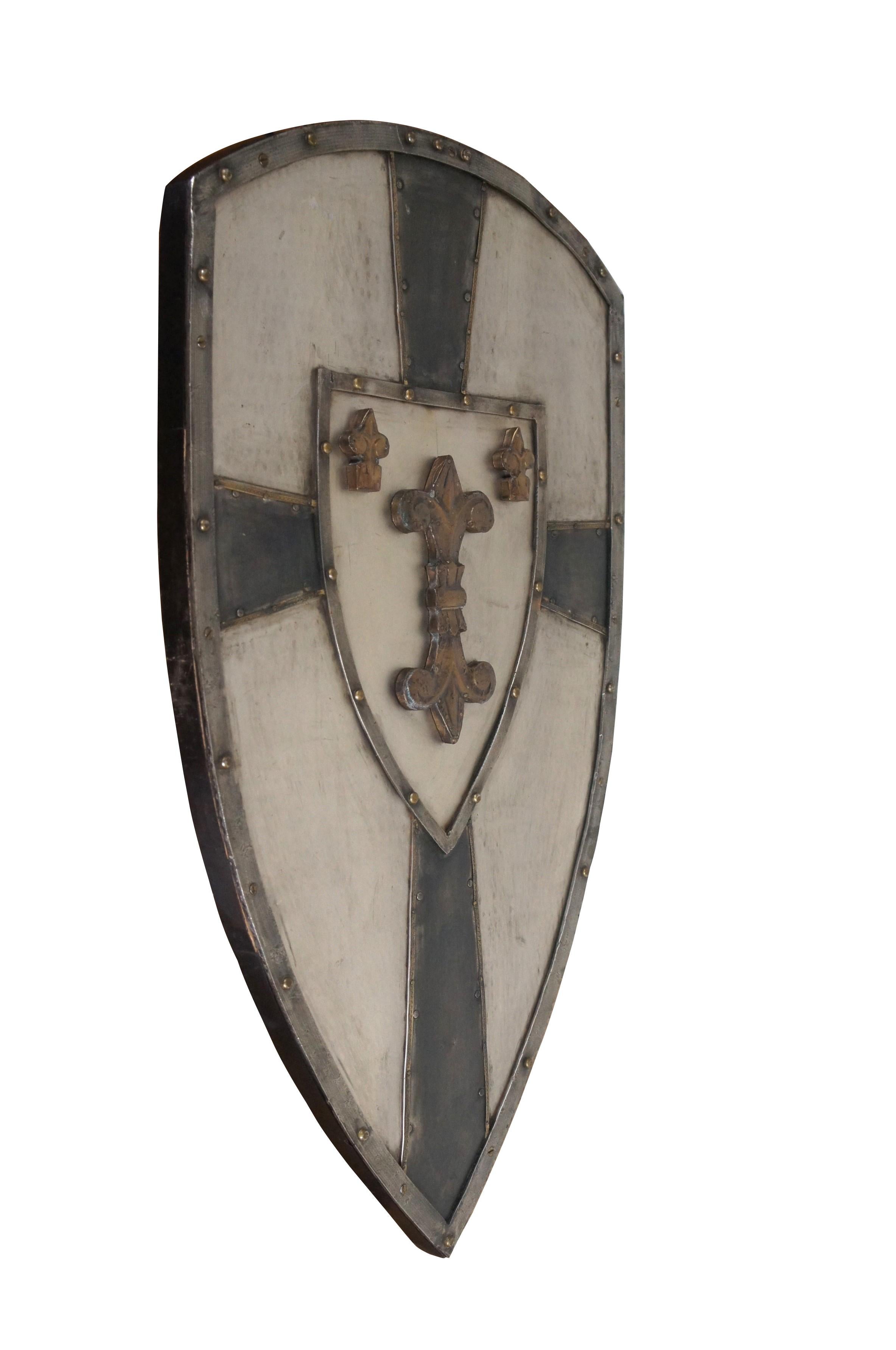 Vintage French Crusader / medieval knight's Heraldic coat of arms shield inspired by the era of Charlemagne. Wooden frame topped with hammered metal, divided with a black crusader's cross around a central motif of a large mirrored fleur de lis