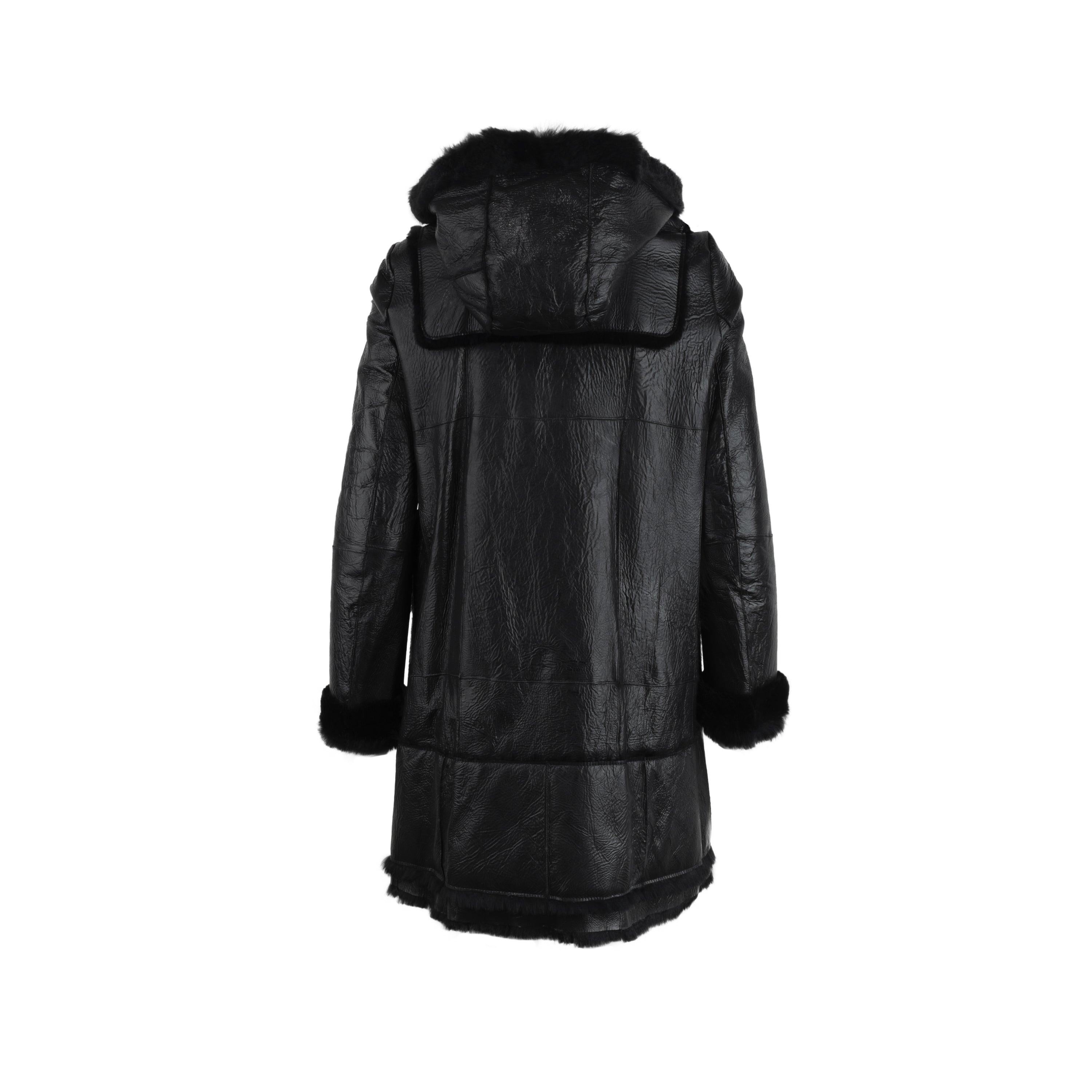 This Charles Anastase black leather coat is an iconic piece crafted in collaboration with 10 Corso Como. With long sleeves, two maxi patch pockets on the front and black fur inserts. WIth the front fastening adorned with smiley buttons, it offers a