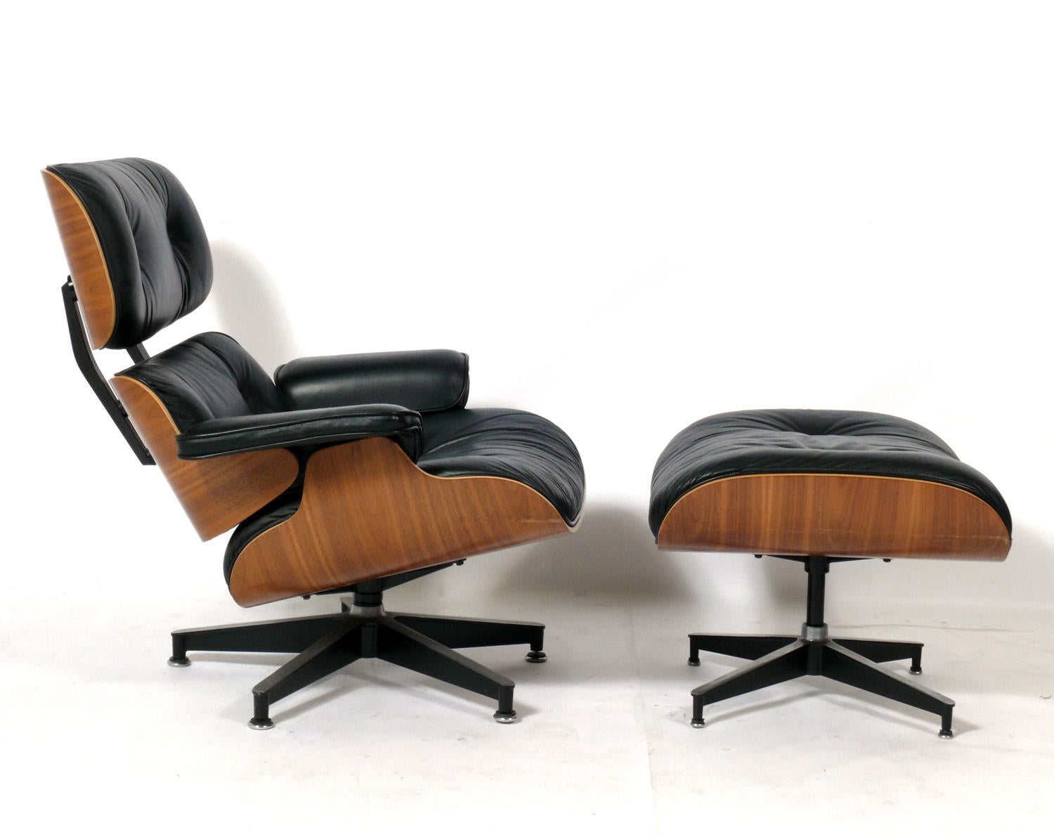 Iconic walnut and black leather lounge chair and ottoman, Model 670 and 671, designed by Charles and Ray Eames for Herman Miller, American, circa 1990s. Signed with Herman Miller tag underneath. Perfectly broken in like your favorite baseball glove.
