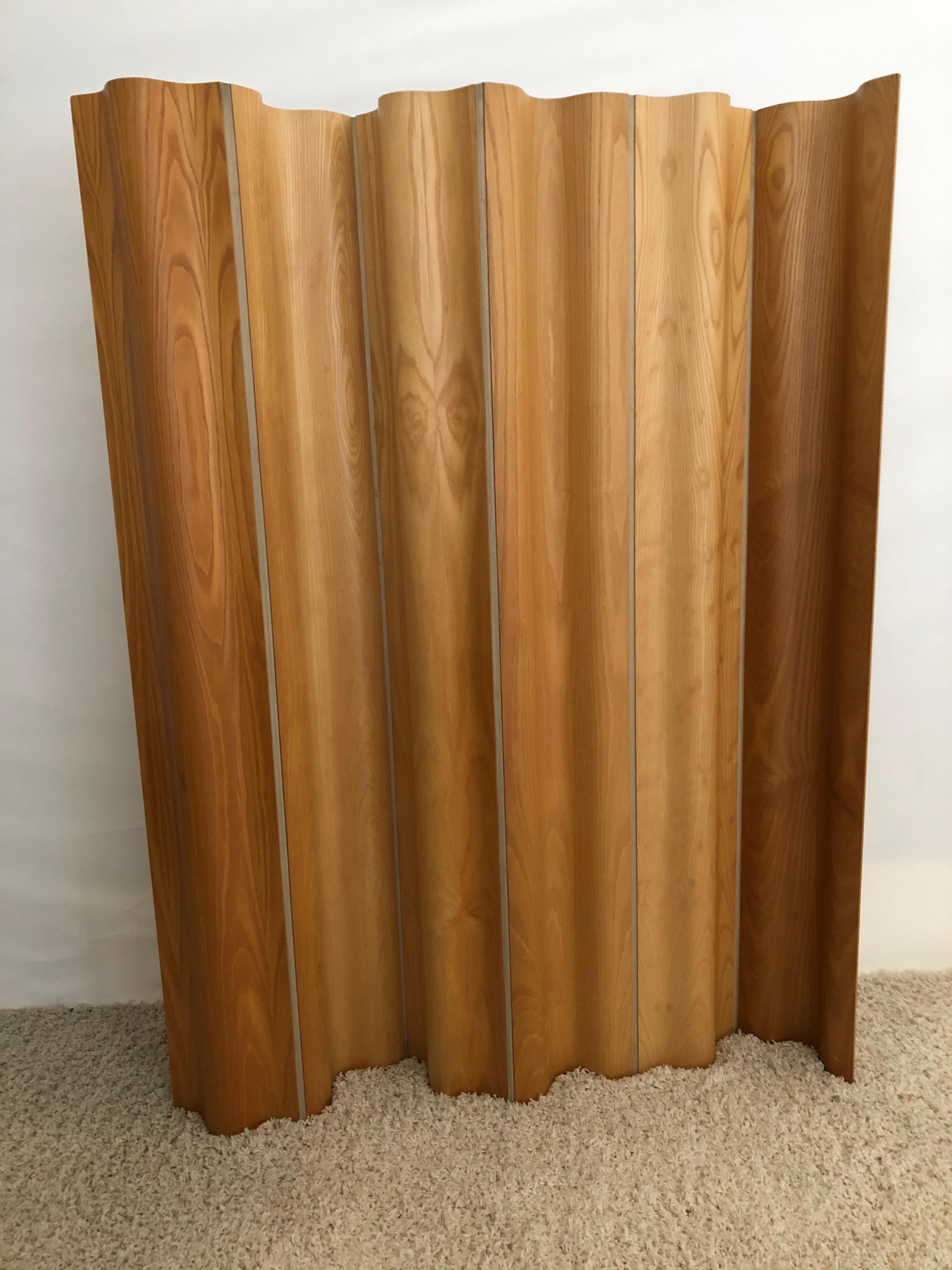 Charles and Ray Eames Iconic two sided molded plywood folding screen, appears to be two different shades of wood each side, shown in photos. Woven canvas in between 6 panels, FSW-6 in original very good fine condition. Very slight imperfections.