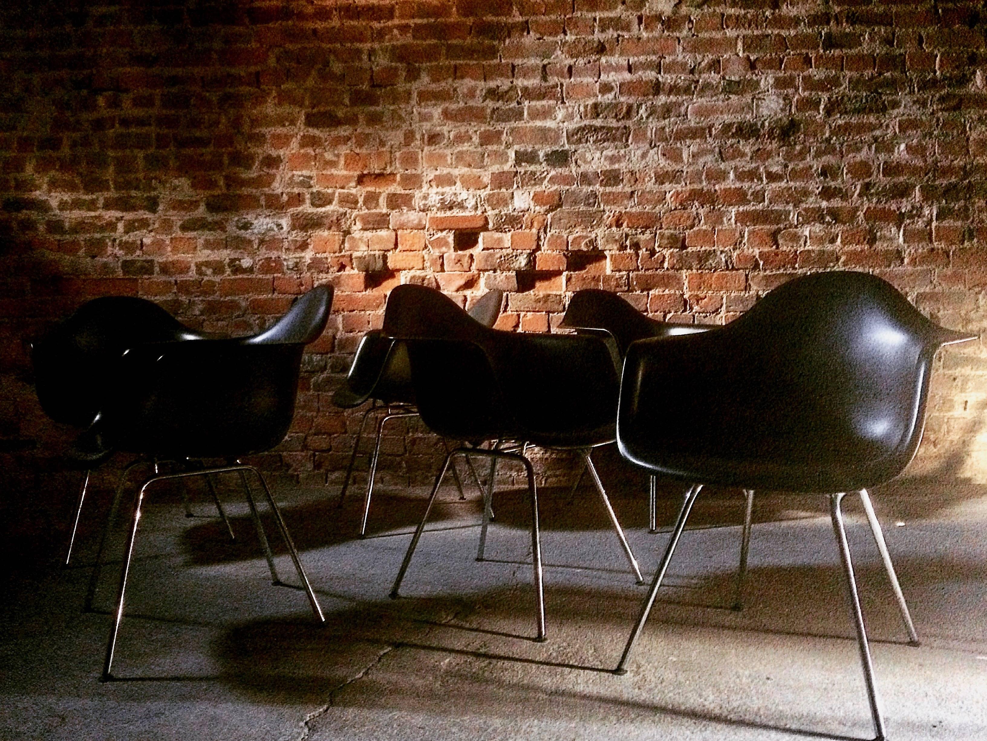 A stunning set of six original vitra DAX chairs in black, the plastic chairs designed by Charles and Ray Eames in 1950 were the very first chairs to be developed out of plastic for Industrial Production. Their organically shaped seat shells are