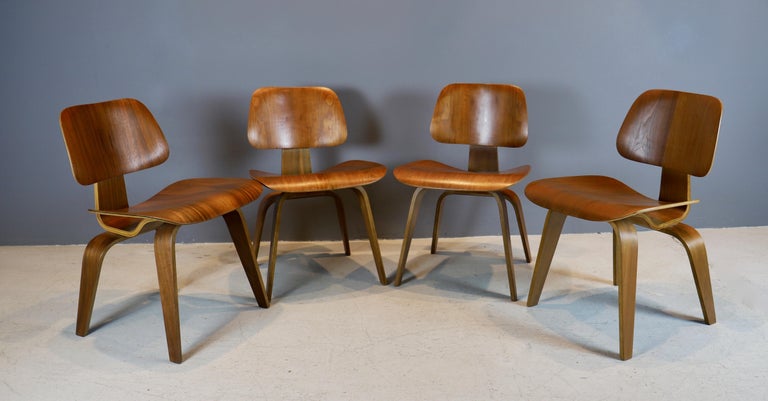 Iconic set of four “DCW” chairs by Charles and Ray Eames in walnut
plywood, circa 1940s - first generation.
Early Evans production, 5/2/5 screw configuration underneath.
Chairs have been cleaned and polished, ready for use.
Old screw repair on
