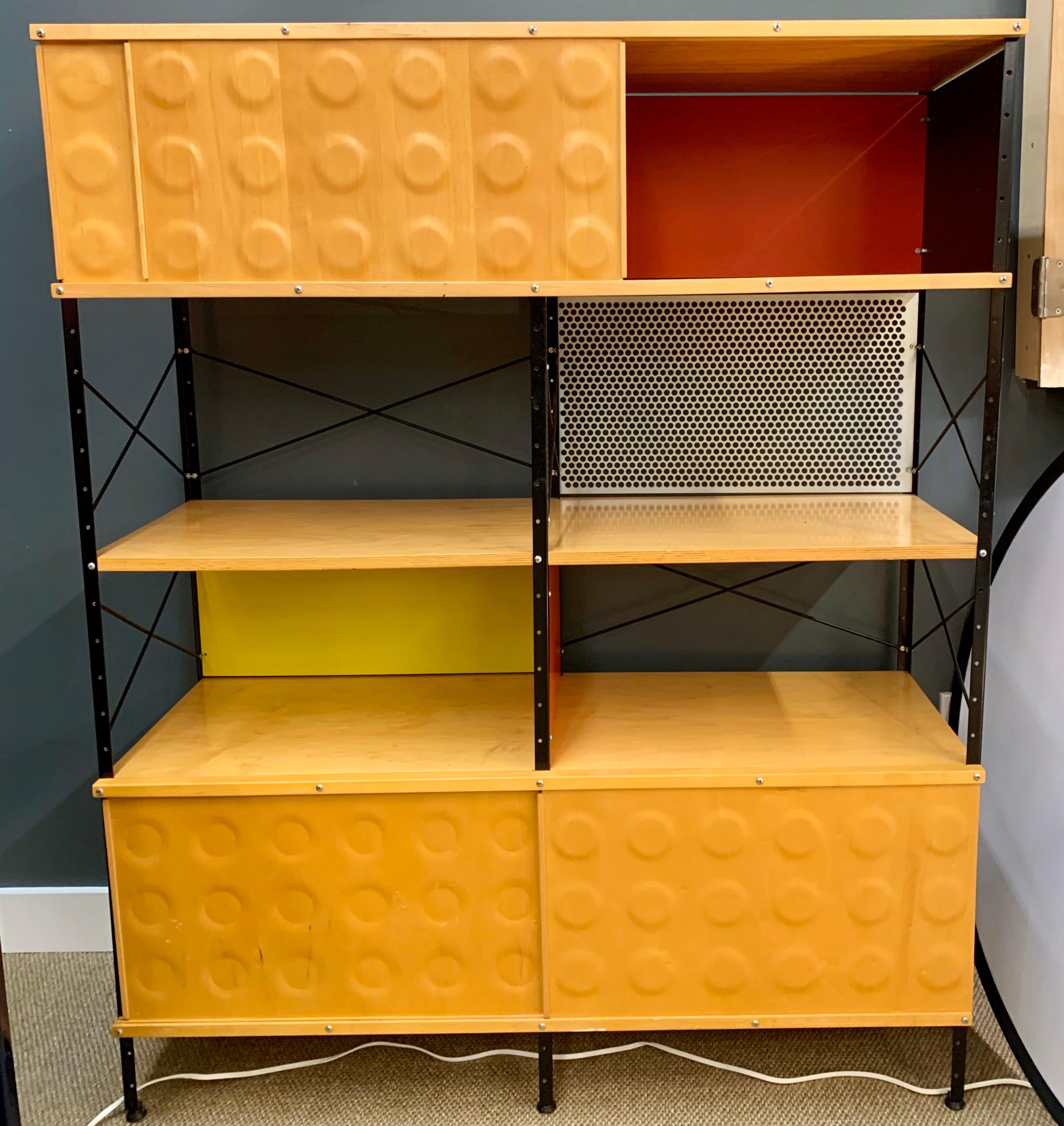 The Charles & Ray Eames ESU 400 N storage unit for Herman Miller. In the USA.
The design features plated steel uprights, and crossed metal struts inspired by industrial warehouse shelving. The walnut wood finish has a beautiful grain with a