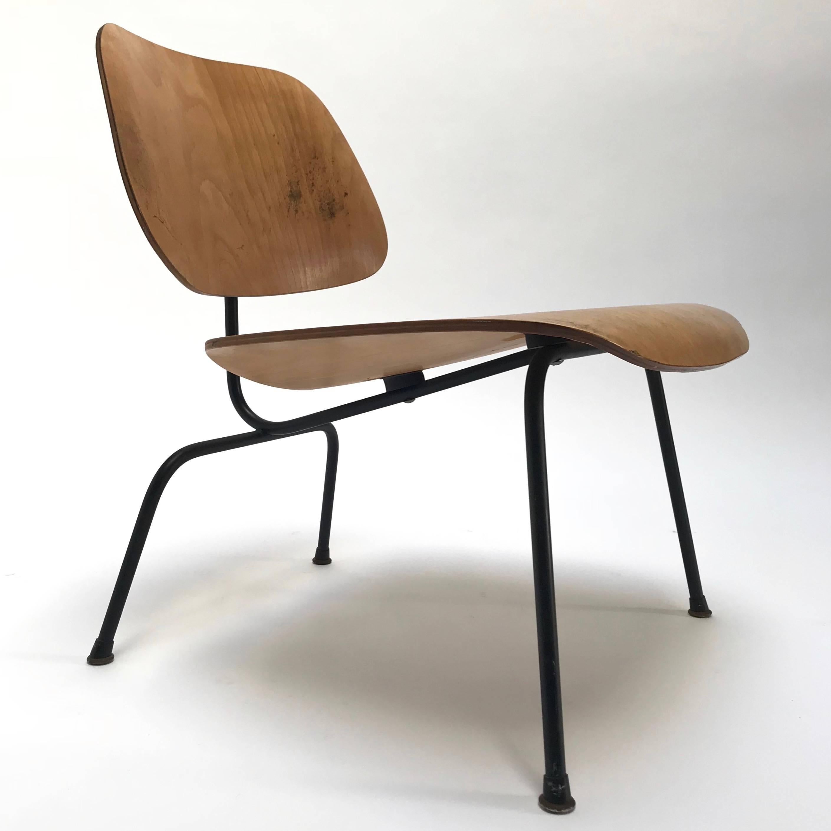 A all original LCM (“Lounge Chair with Metal base”) chair in birch by Charles and Ray Eames for Herman Miller, circa 1952.

Birch veneer over molded plywood seat on matte black steel base. Original and complete hardware, early boot glides, and