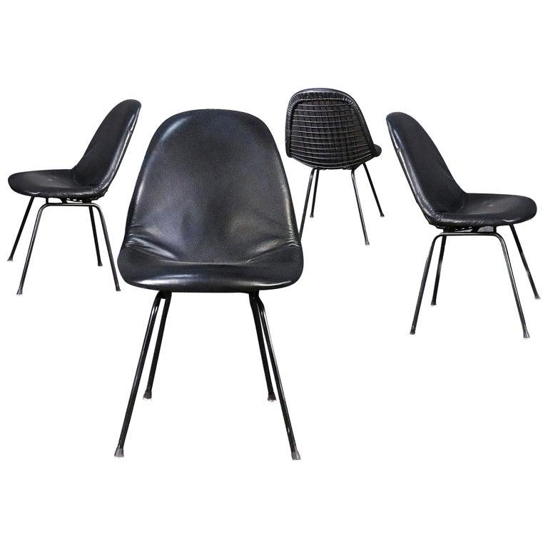 Charles and Ray Eames for Herman Miller DKX-1 chair, black leather, H-base, circa 1954, Boot glides 
The abbreviated Eames DKX chair, part of the Wire Mesh Series, stood for Dining (D) height, K-Wire (K) chair on X-base (X). As with all the mesh