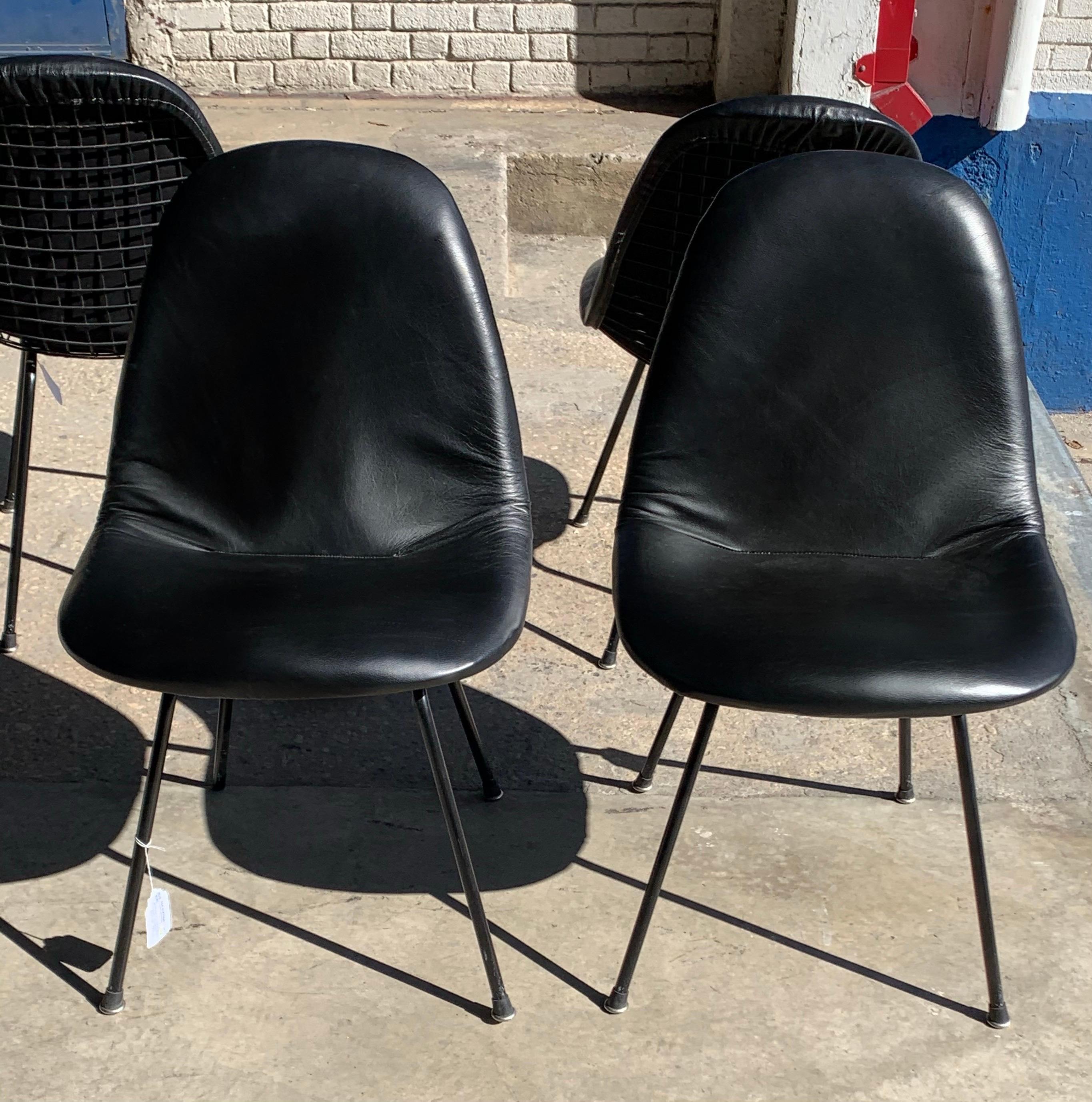 Charles and Ray Eames for Herman Miller DKX-1 chair, black leather, H-base, circa 1954, Boot glides .Pricing is per chair. Please change quantity to 4 to purchase entire set.

The abbreviated Eames DKX chair, part of the Wire Mesh Series, stood for