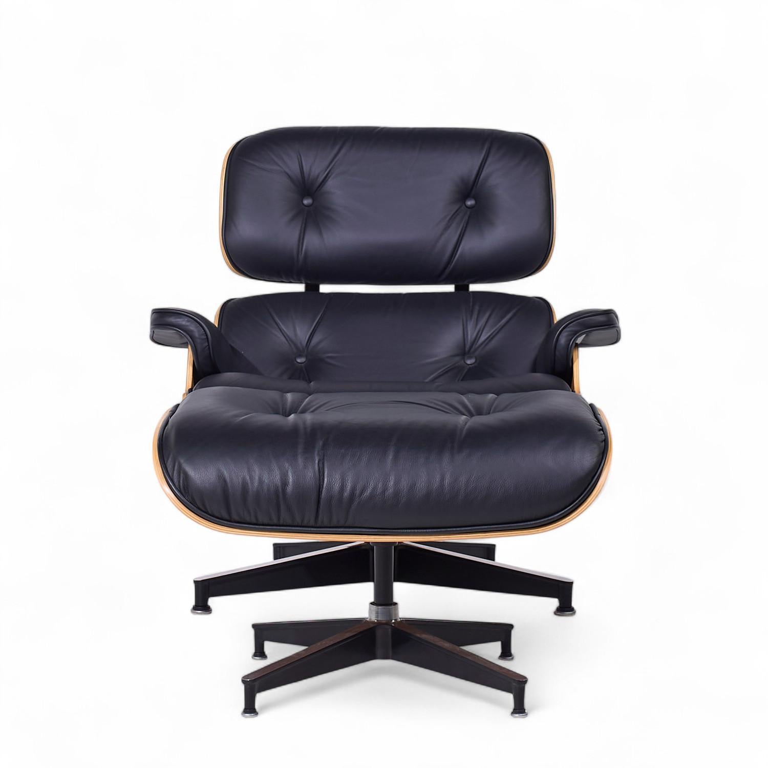 Charles and Ray Eames for Herman Miller Mid Century Walnut Chair and Ottoman

The chair measures: 33 wide x 35 deep x 31.75 high, with a seat height of 17 inches and arm height/chair clearance of 20.5 inches
The ottoman measures: 26.25 wide x 22