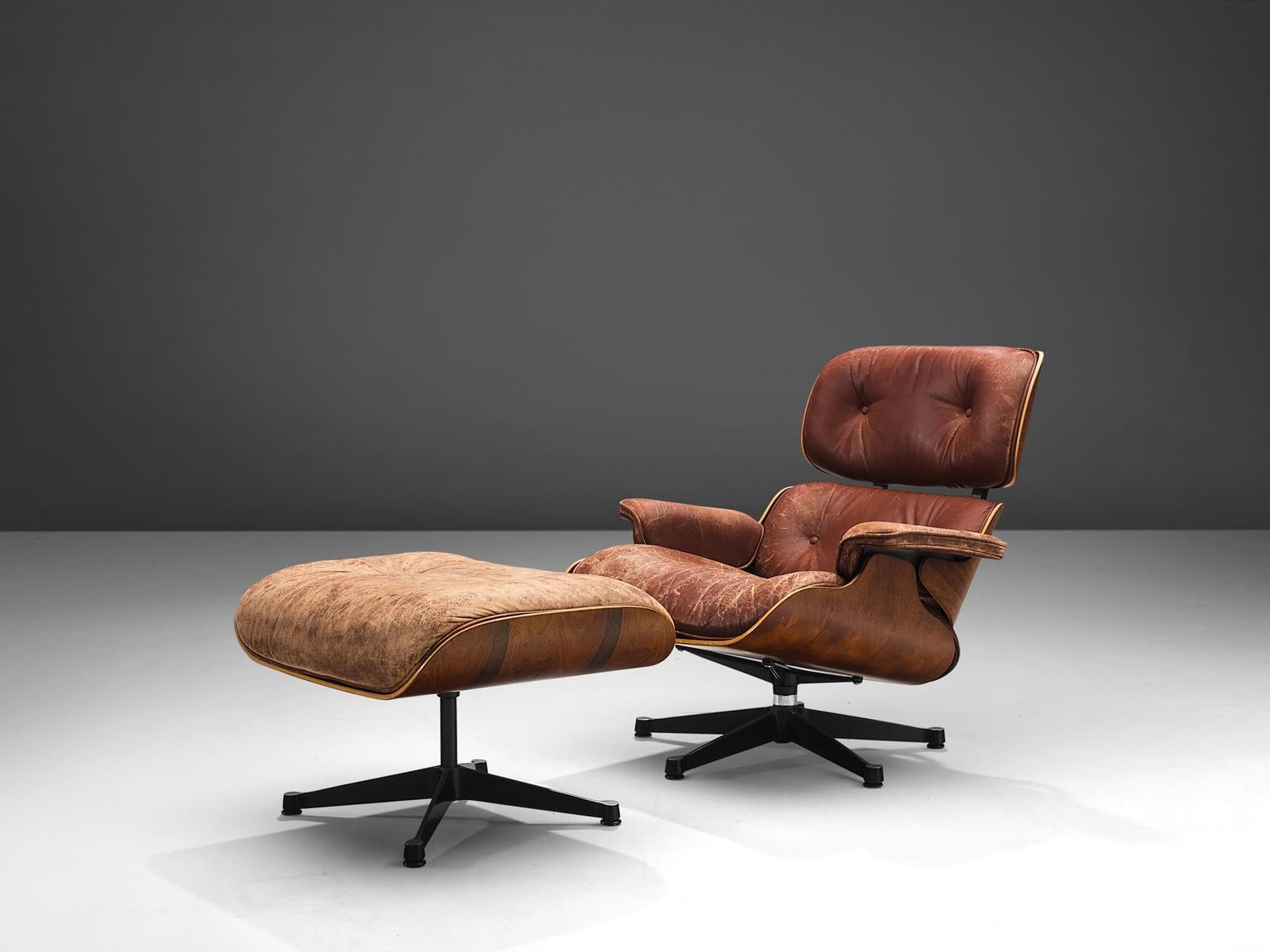 Charles and Ray Eames, lounge chairs and ottoman, with brown colored leather and rosewood, United States, 1956 design, 1960s production.

This iconic set by Charles and Ray Eames is the modernist take on the English club chair and has been the